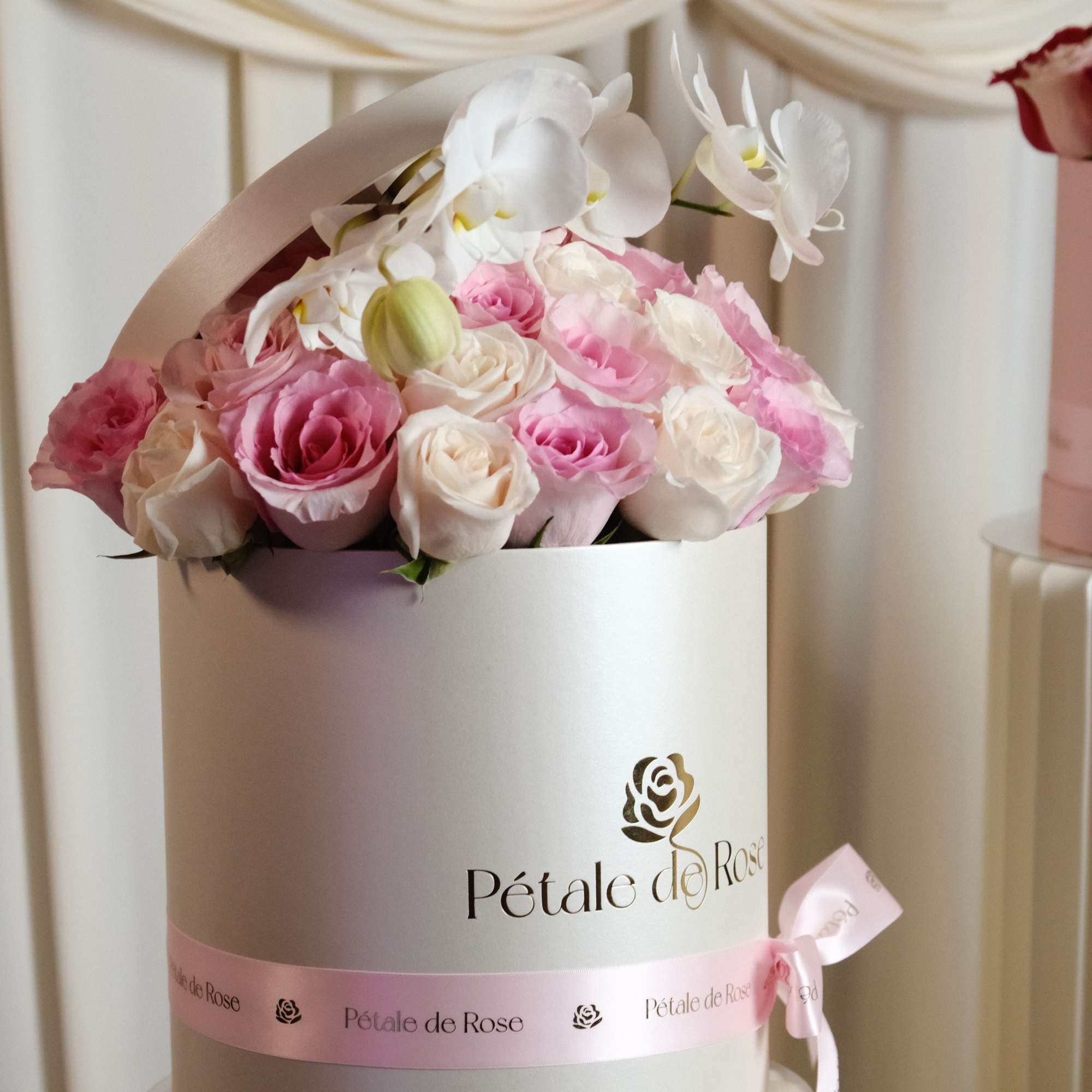 A timeless luxury arrangement featuring blush and ivory roses topped with elegant