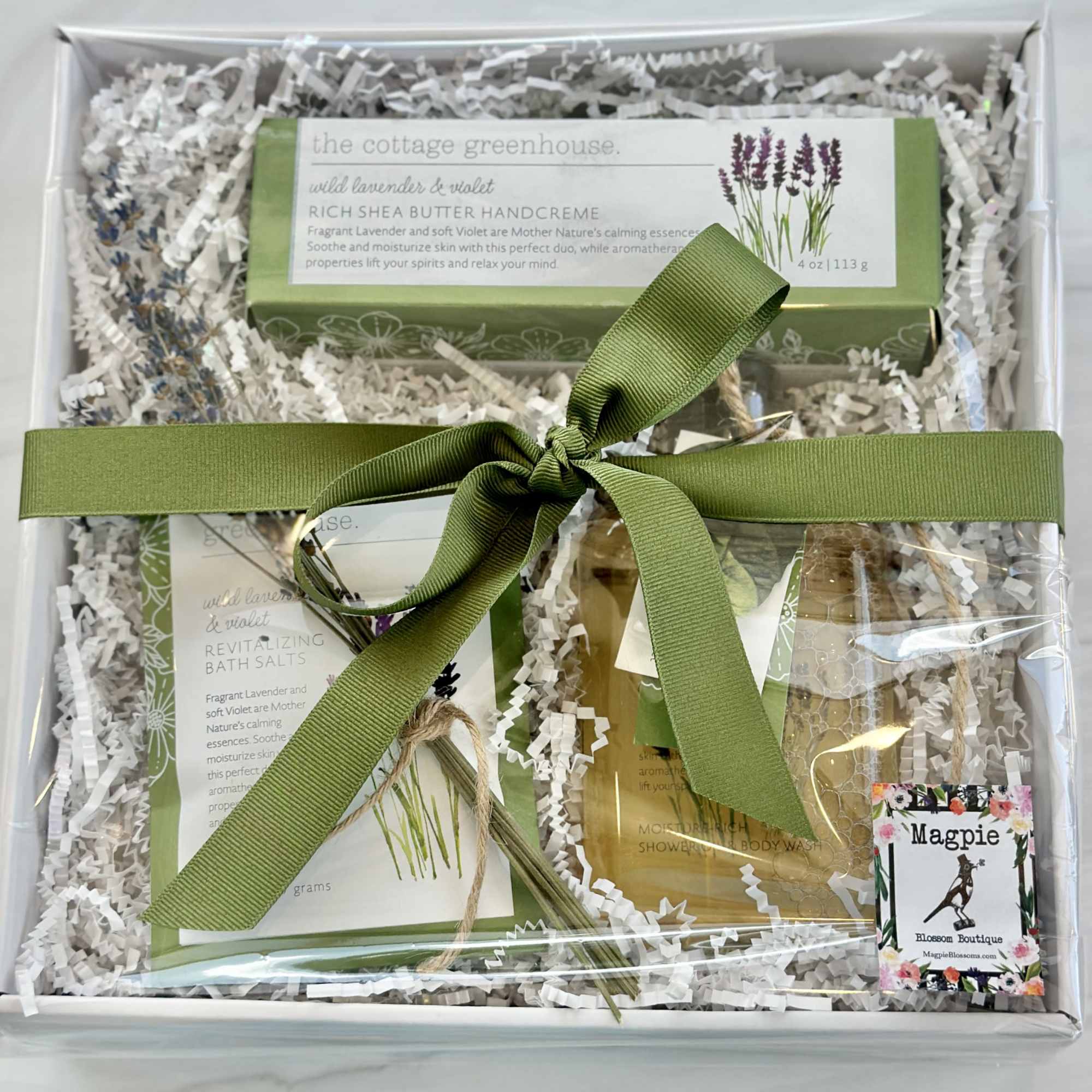 Gift box with lavender bath products tied with a green ribbon