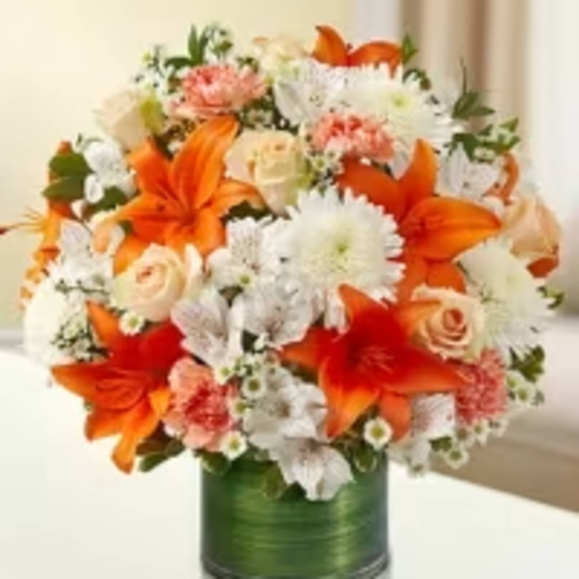 Bright bursts of orange Asiatic lilies steal the show in this Citrus