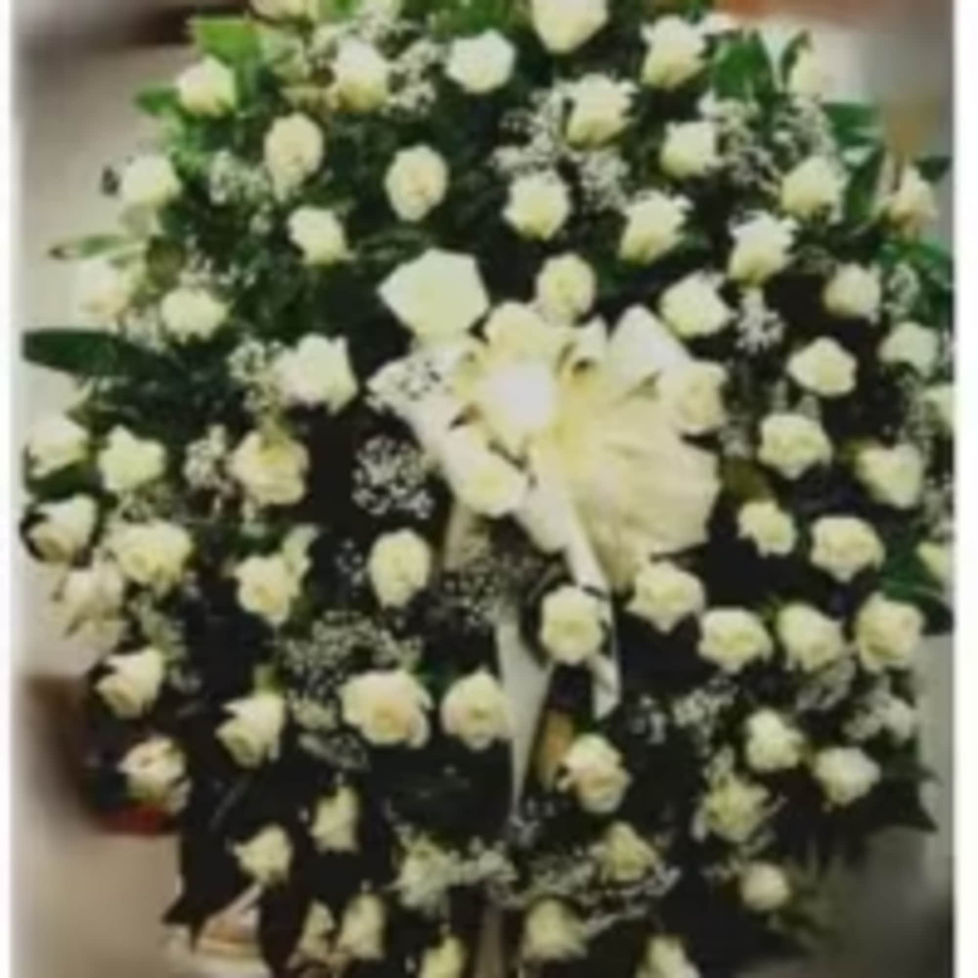 A full circle of pure white roses and lilies creates a calm