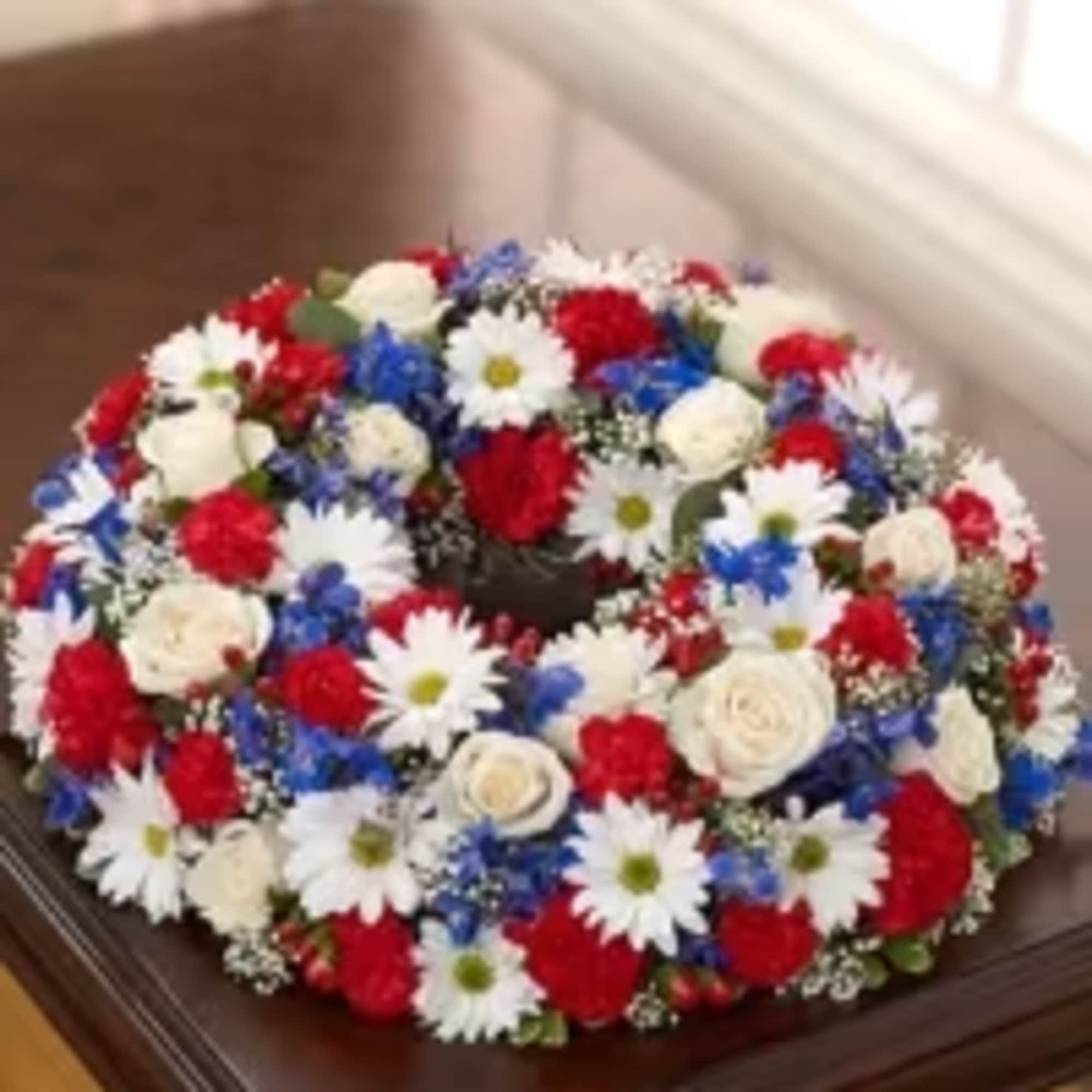 A tightly packed ring of red, white, and blue blooms creates an