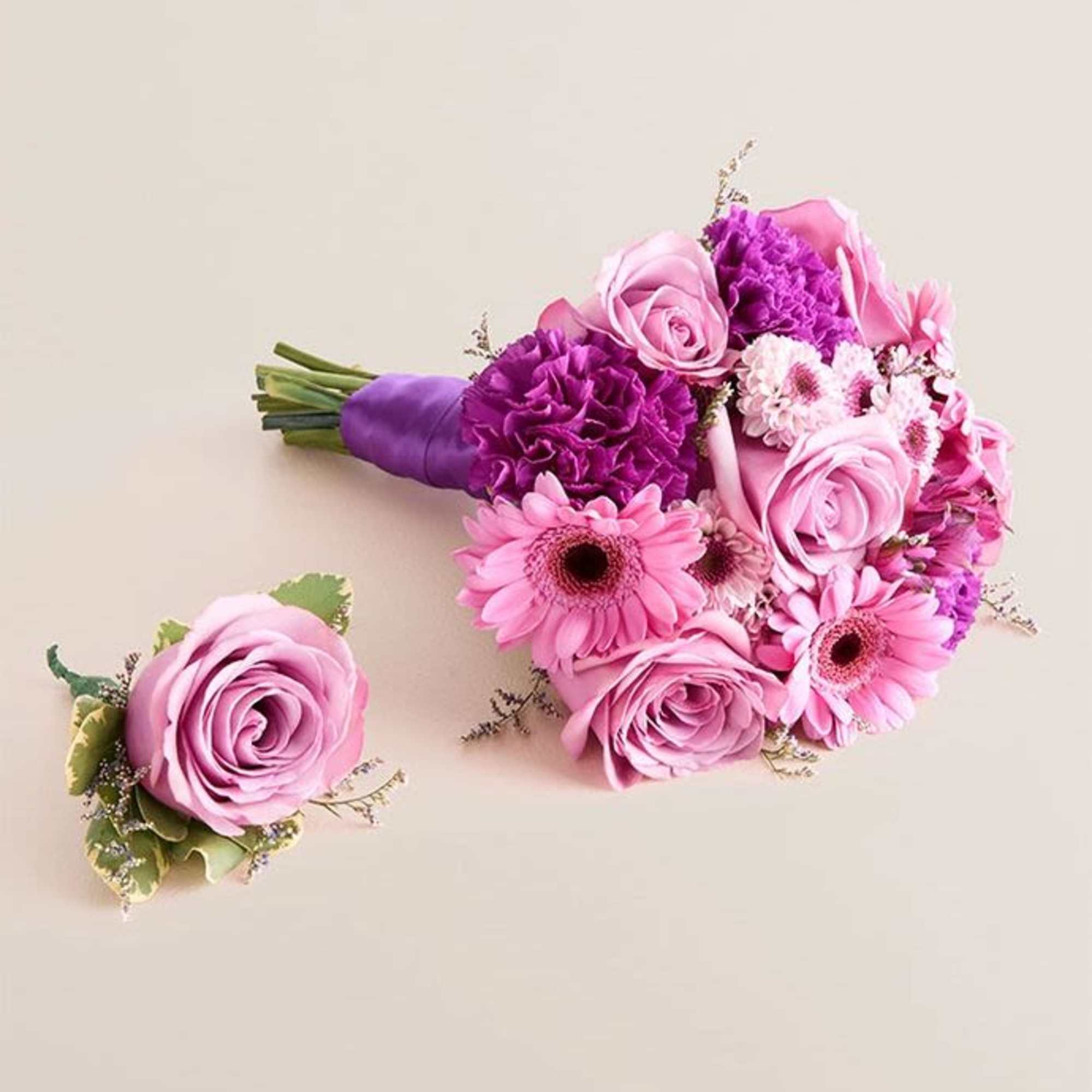 A compact, hand-tied bouquet in pink, purple and white that reads instantly