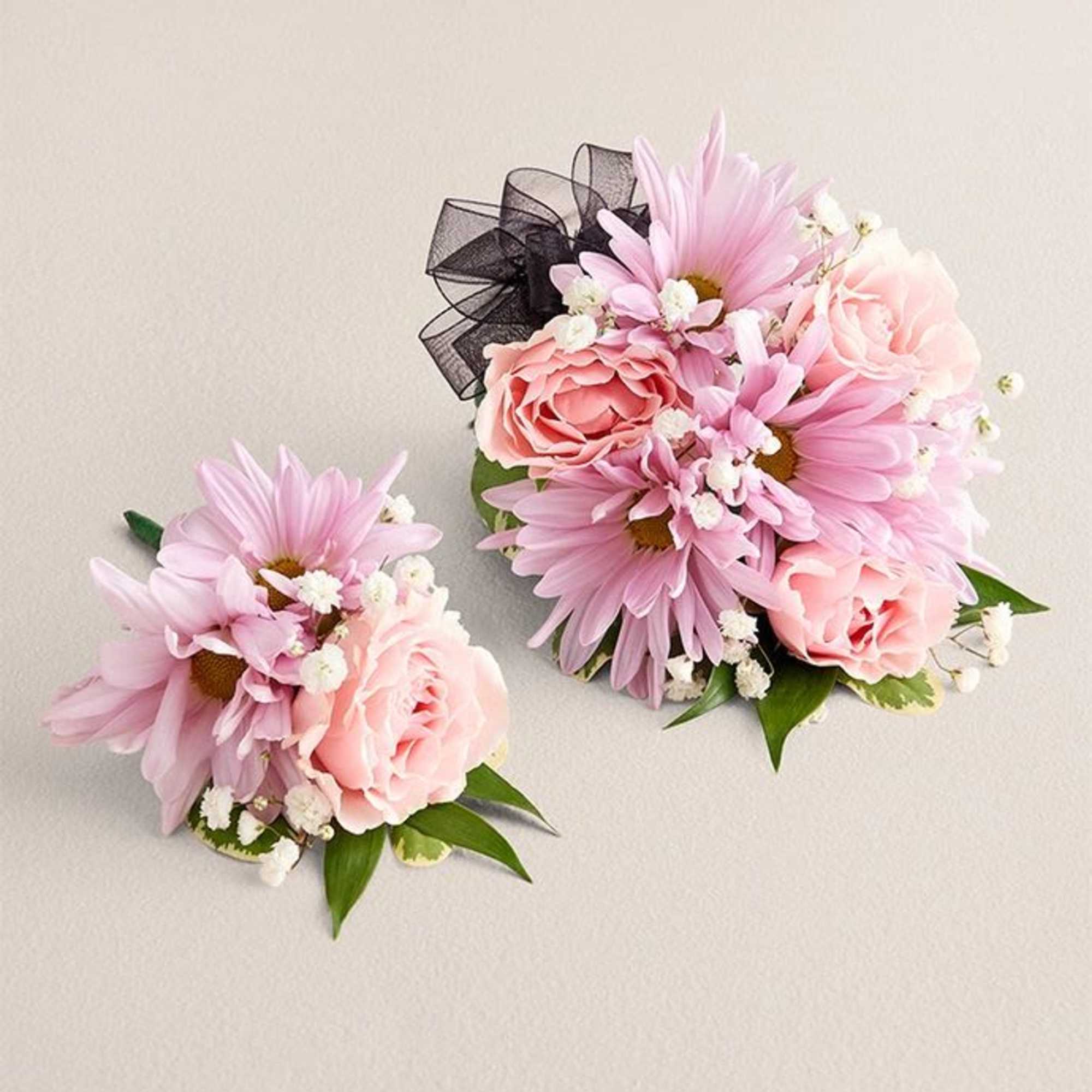 Soft pink daisies and blush roses paired with tiny white filler blossoms