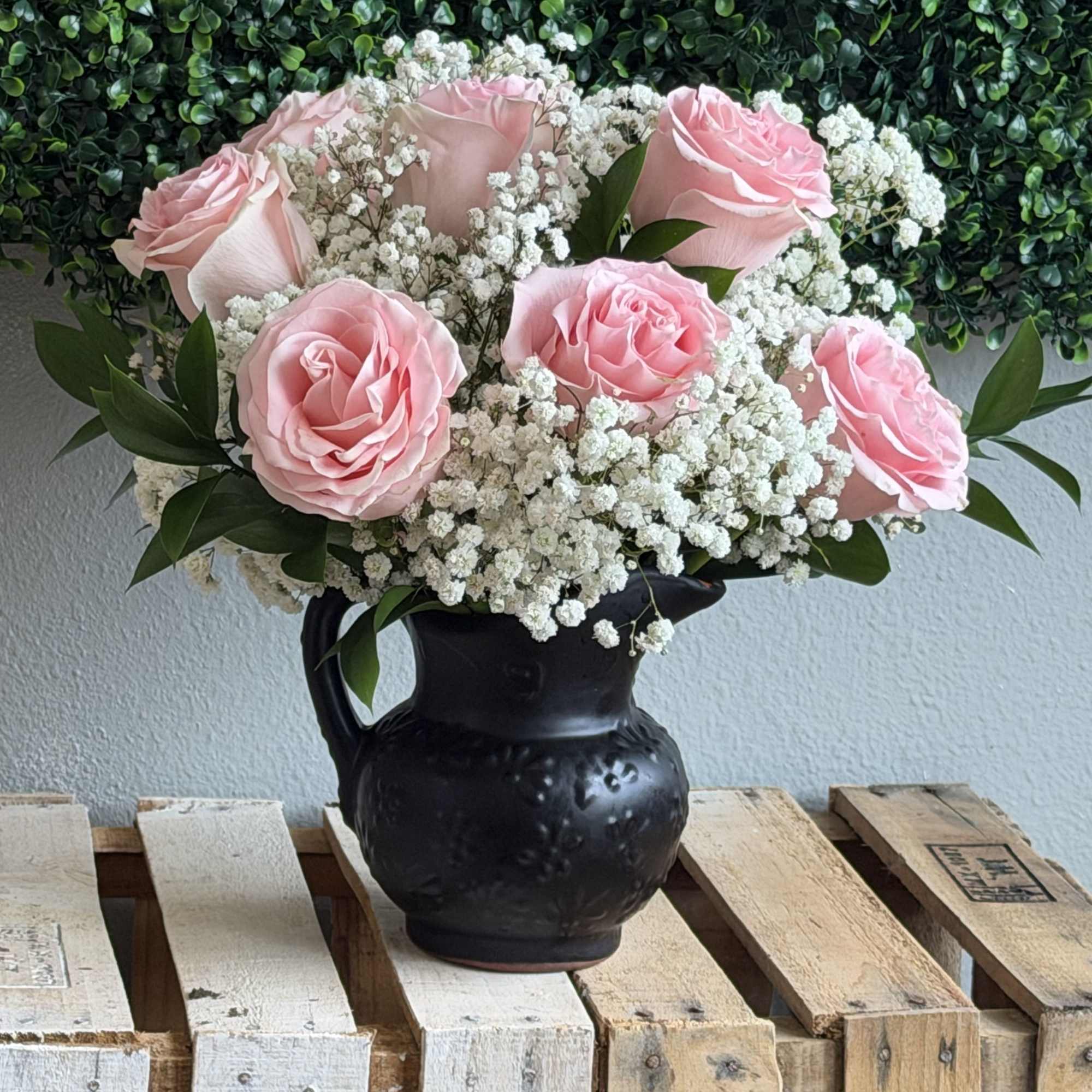 Soft pink roses gathered into a tight, rounded bouquet create a soft