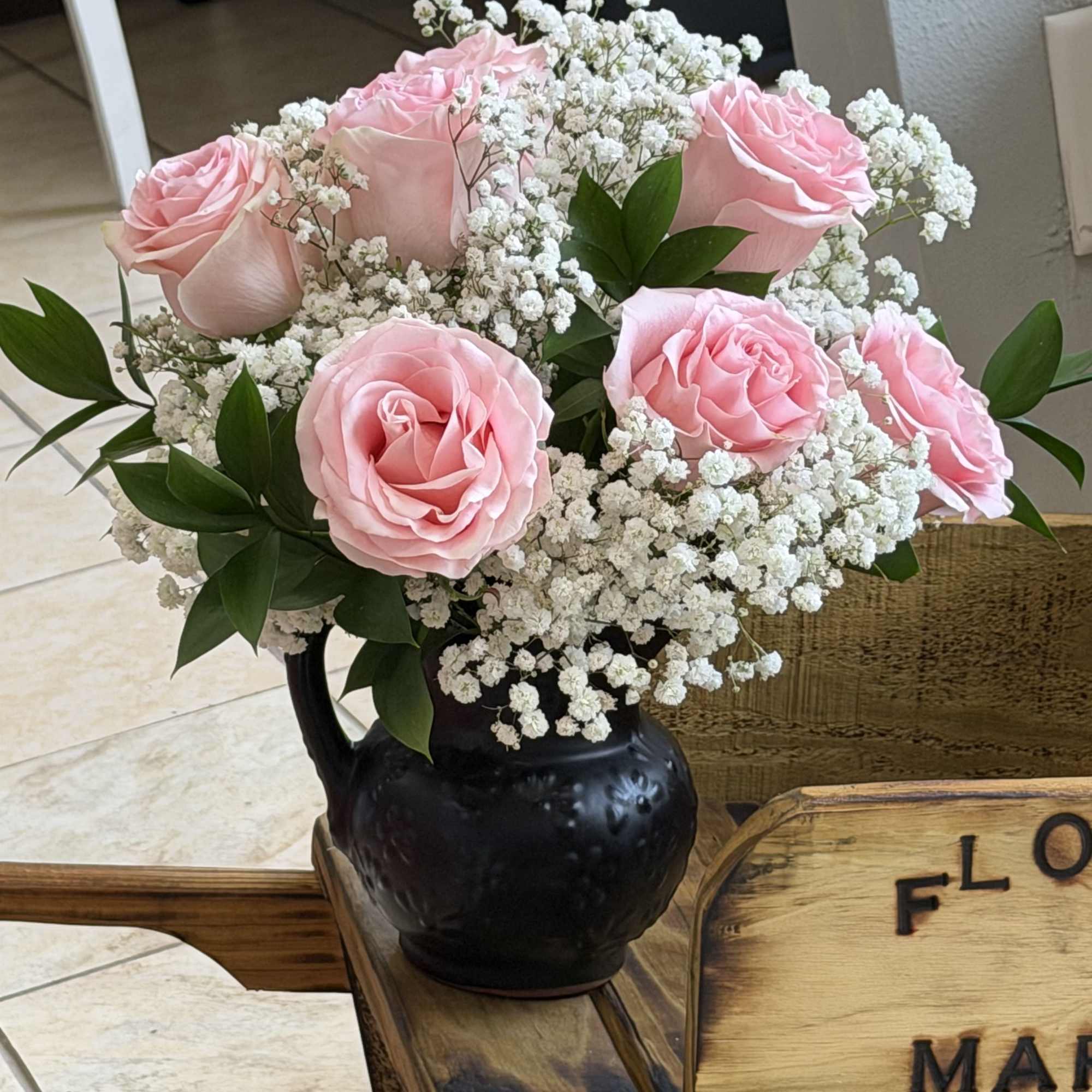 Soft pink roses gathered into a tight, rounded bouquet create a soft