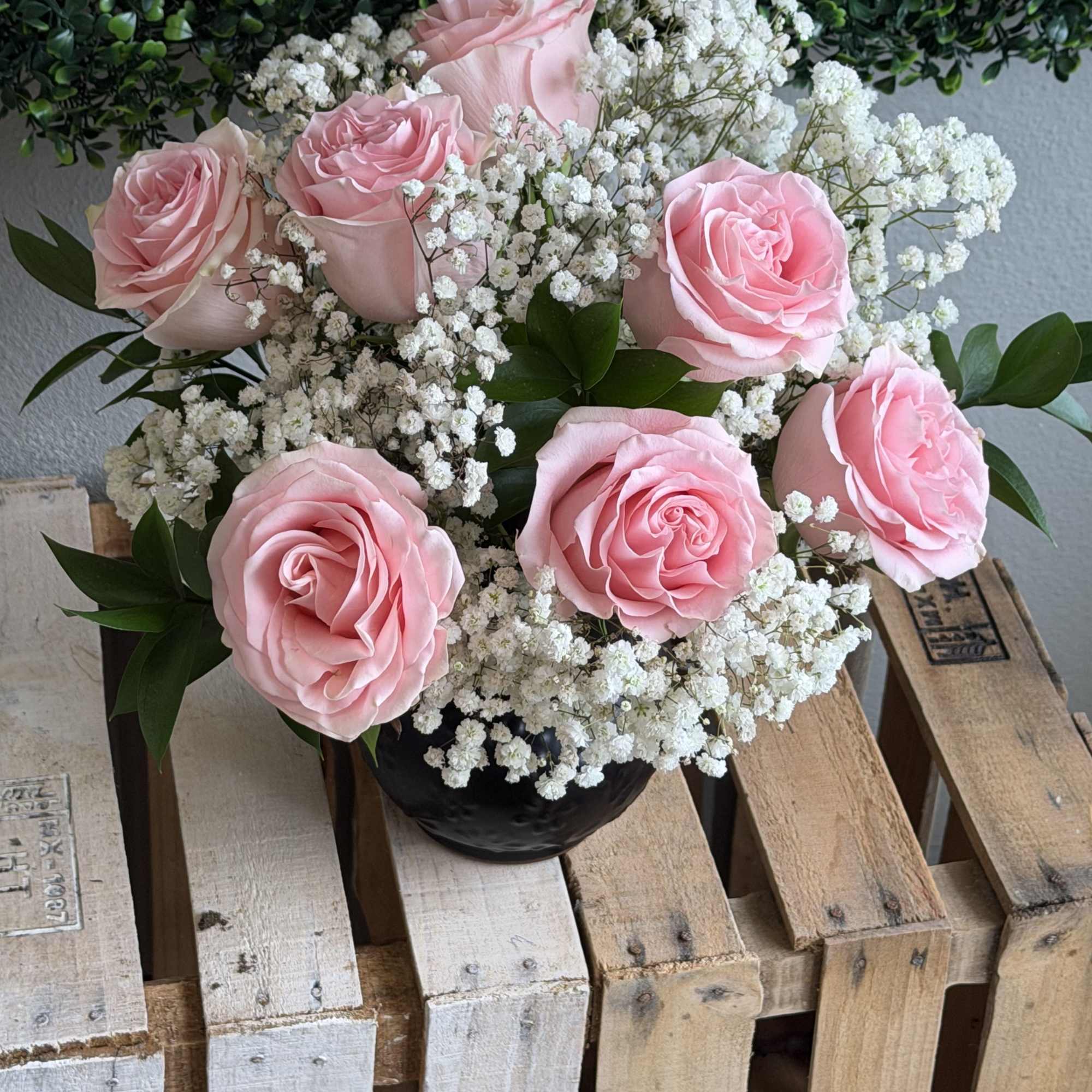 Soft pink roses gathered into a tight, rounded bouquet create a soft