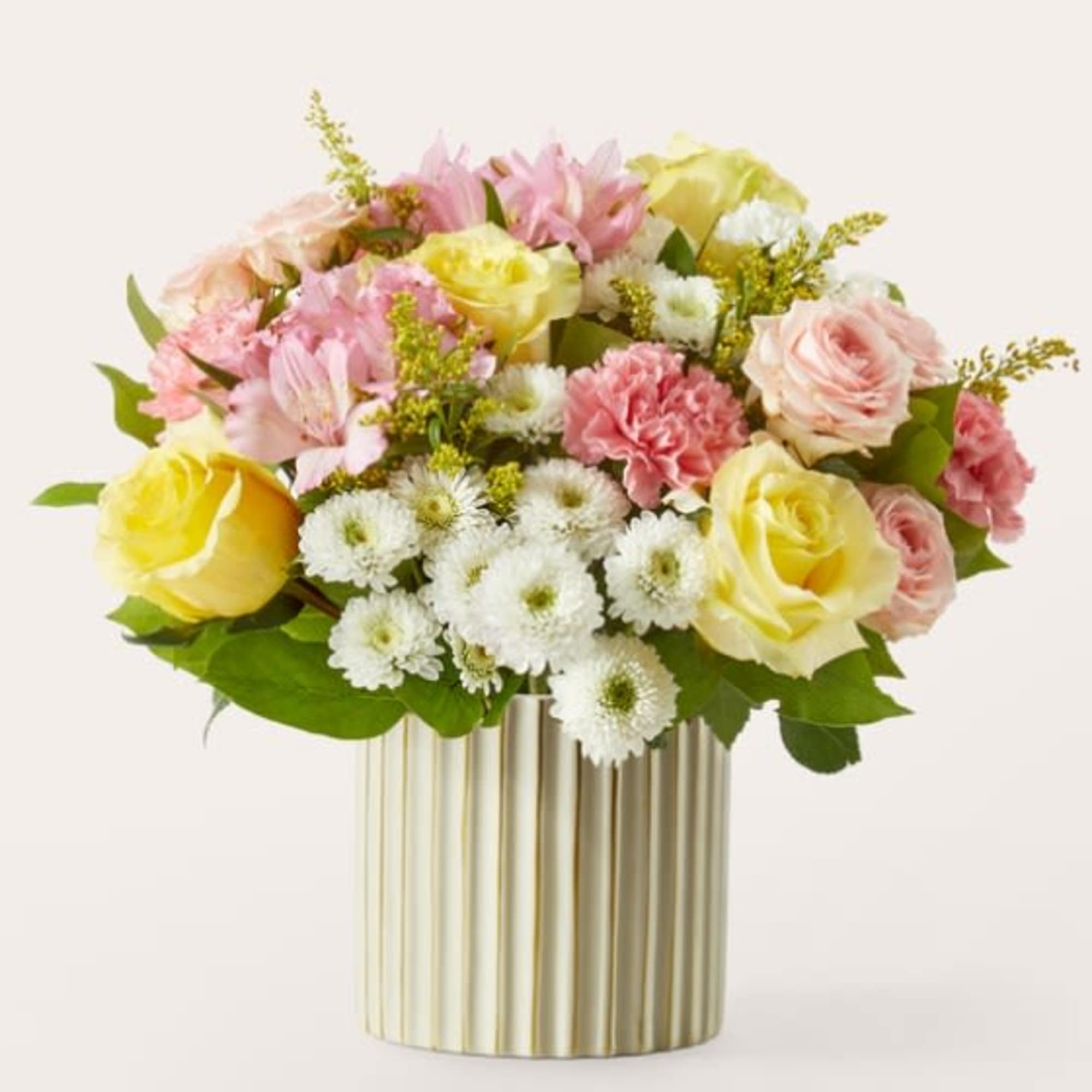 Mixed bouquet of pink and yellow roses in a gold vase