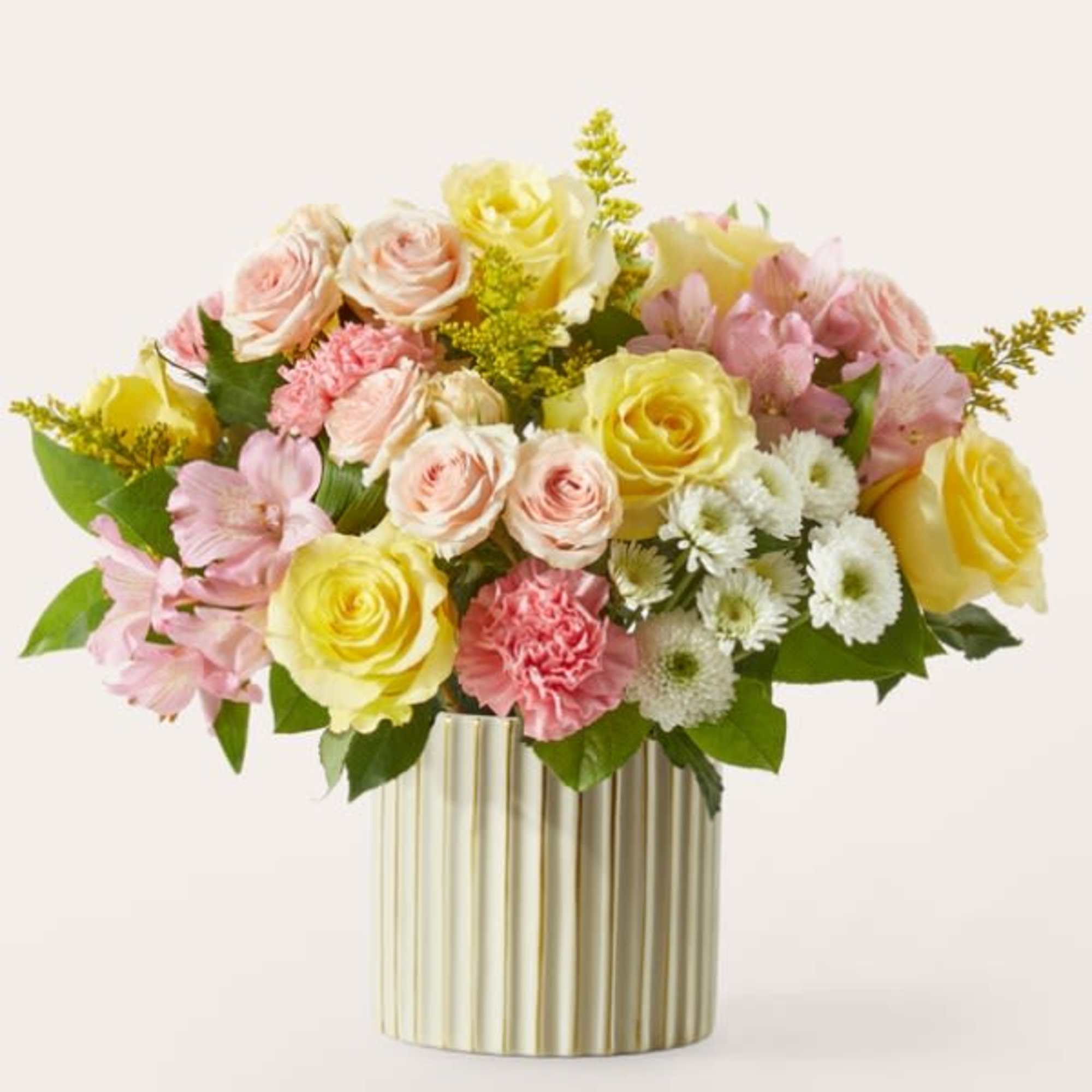 Pink and yellow rose bouquet in a gold striped vase
