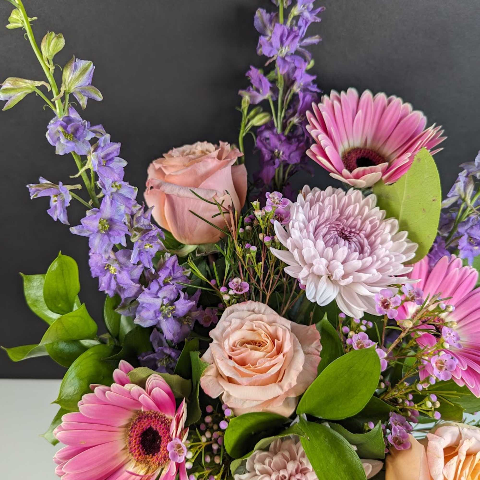 Pink and lavender mixed bouquet with roses, gerbera daisies, and chrysanthemums