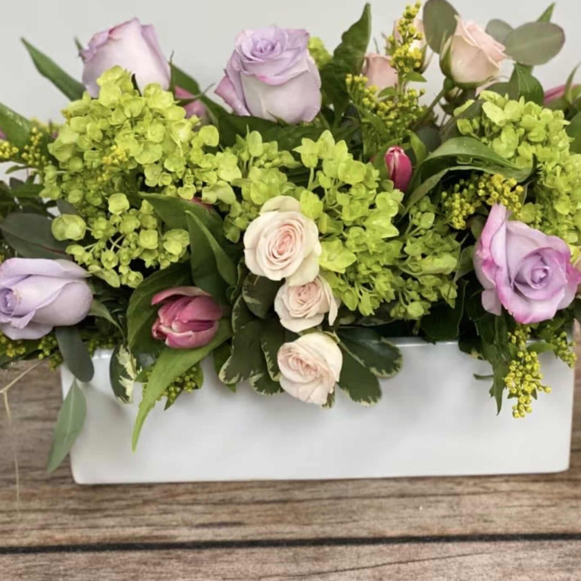 An oblong, low centerpiece perfect for a table centerpiece. Approx. 14" long.