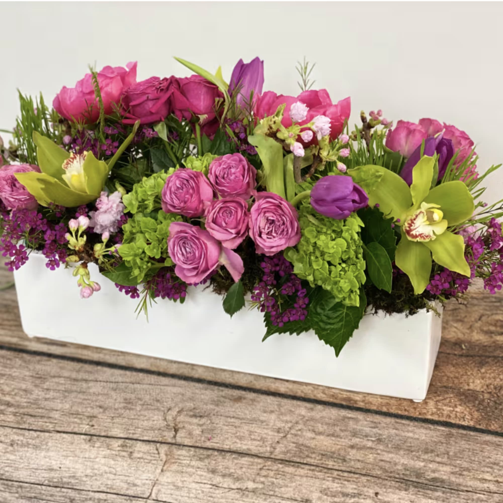 An oblong, low centerpiece perfect for a table centerpiece. Approx. 14" long.