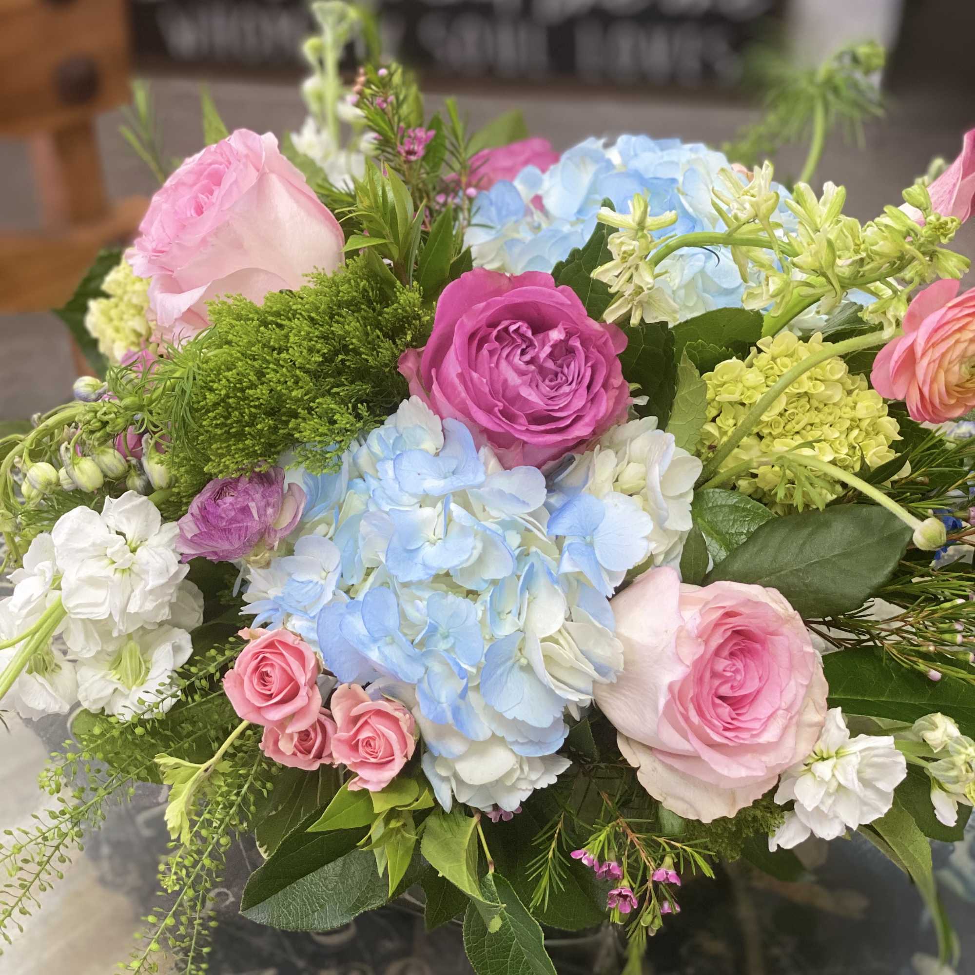 Pink roses and blue hydrangeas in a mixed bouquet