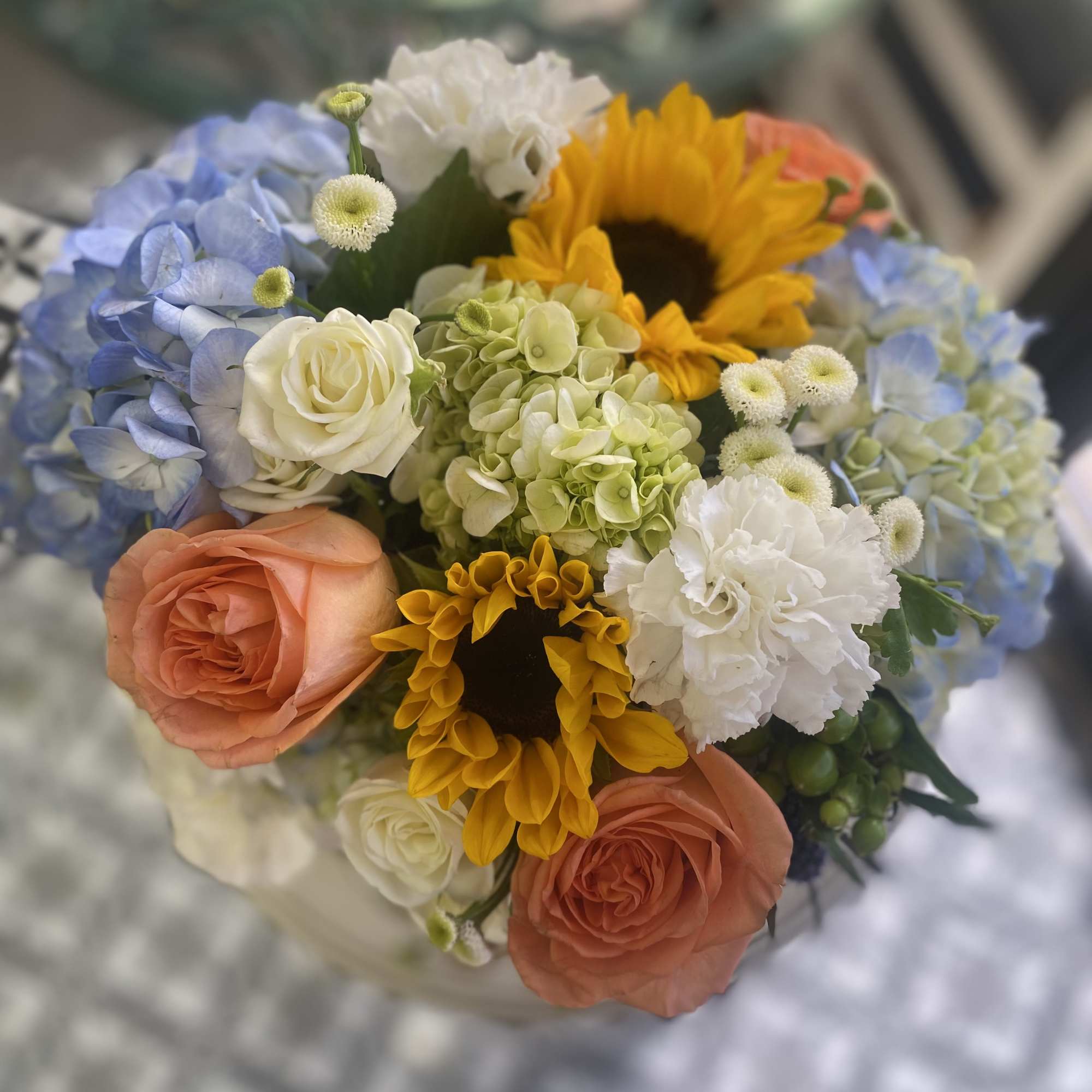 Mixed bouquet with sunflowers, roses, hydrangeas, and carnations