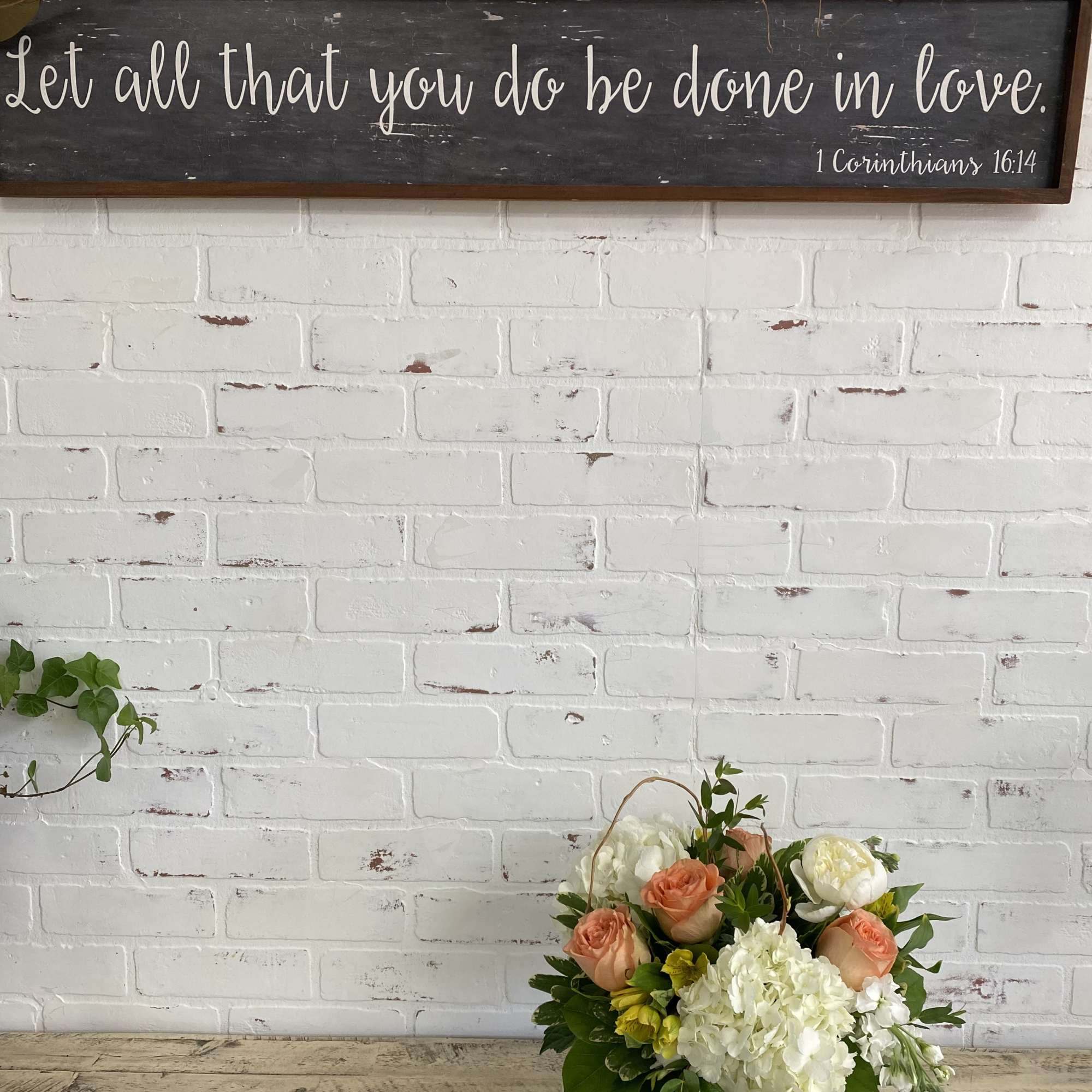 Mixed bouquet in a white vase with peach roses and white blooms