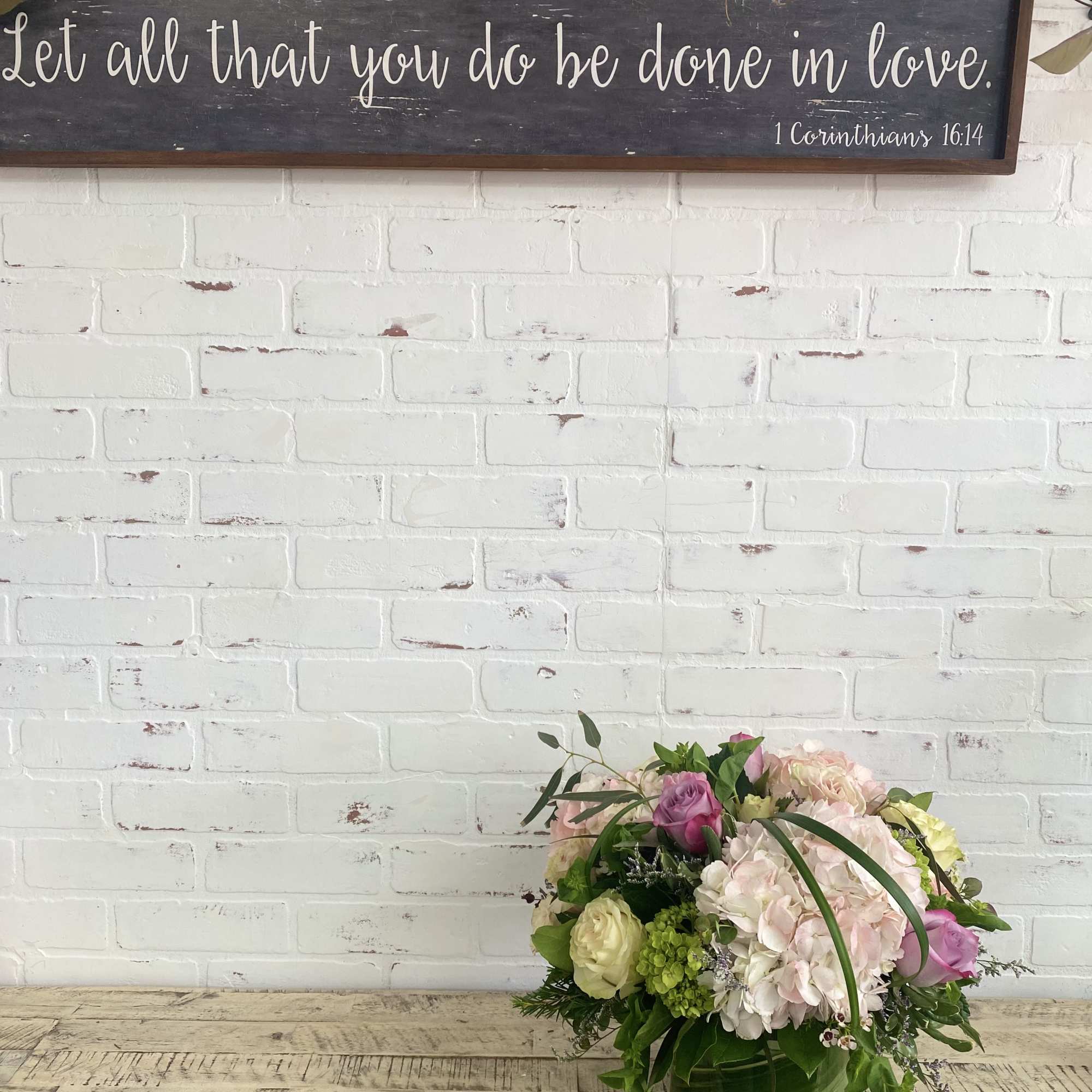 Light colored blooms of soft pinks, whites, green, and touches of purple.