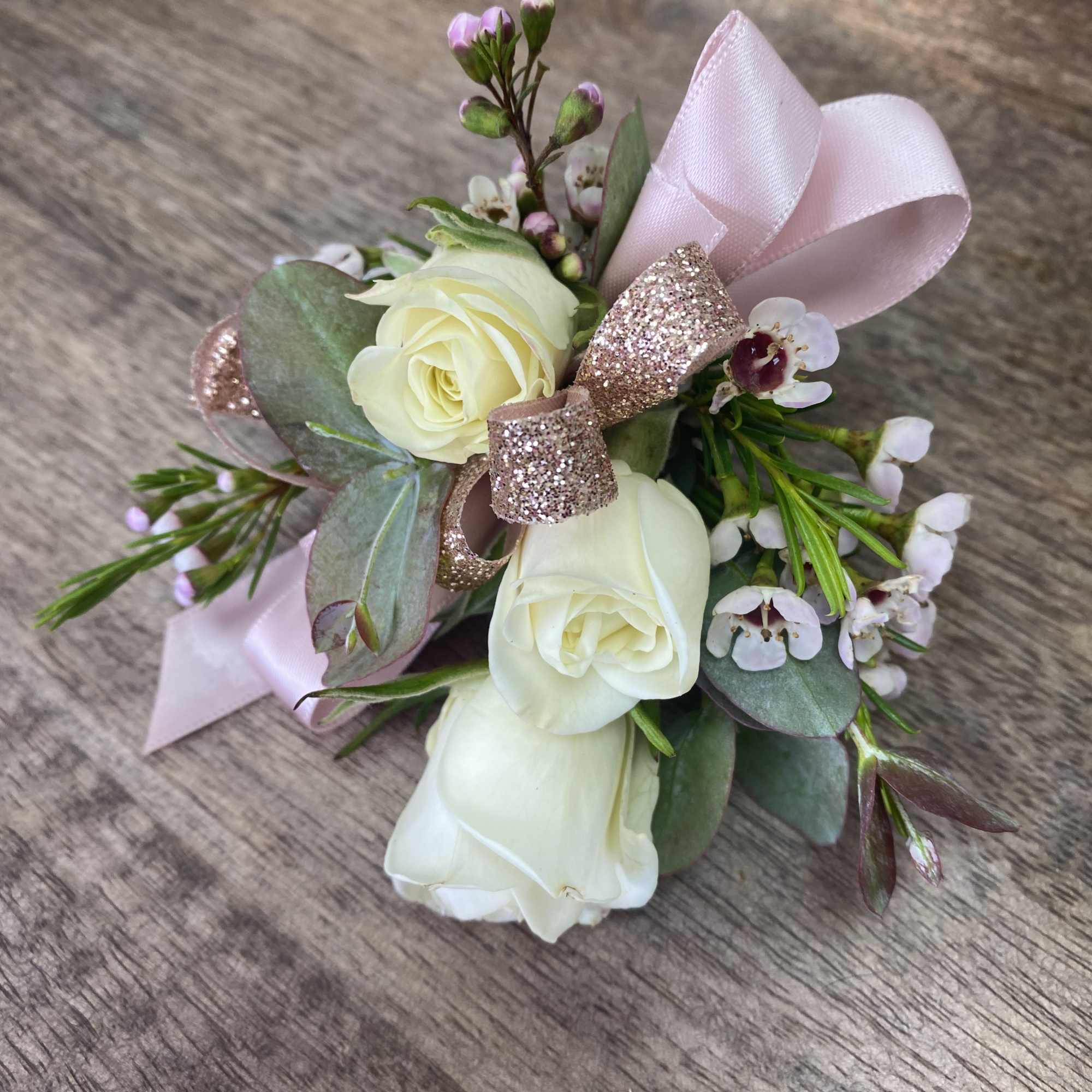 Small bouquet of white roses with pink ribbon and glitter bow