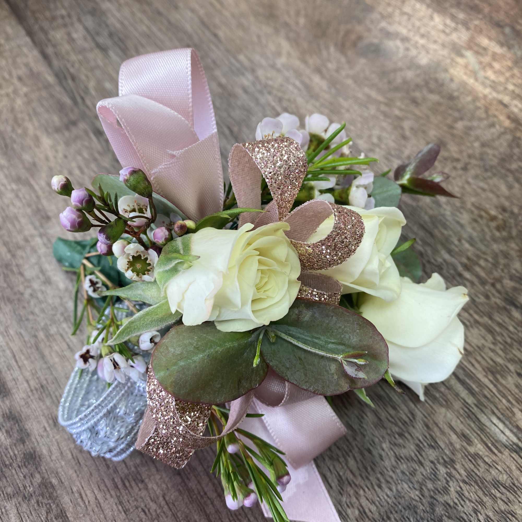 Small bouquet of white roses with pink ribbon and glitter accents