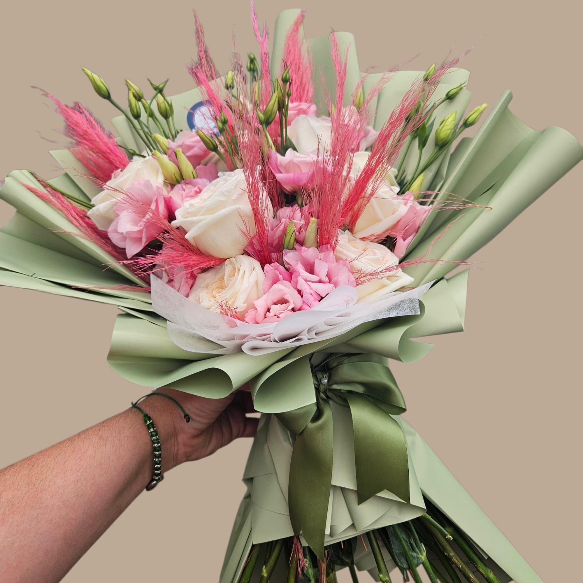 Blush pink and creamy white roses mingle with soft pink lisianthus and