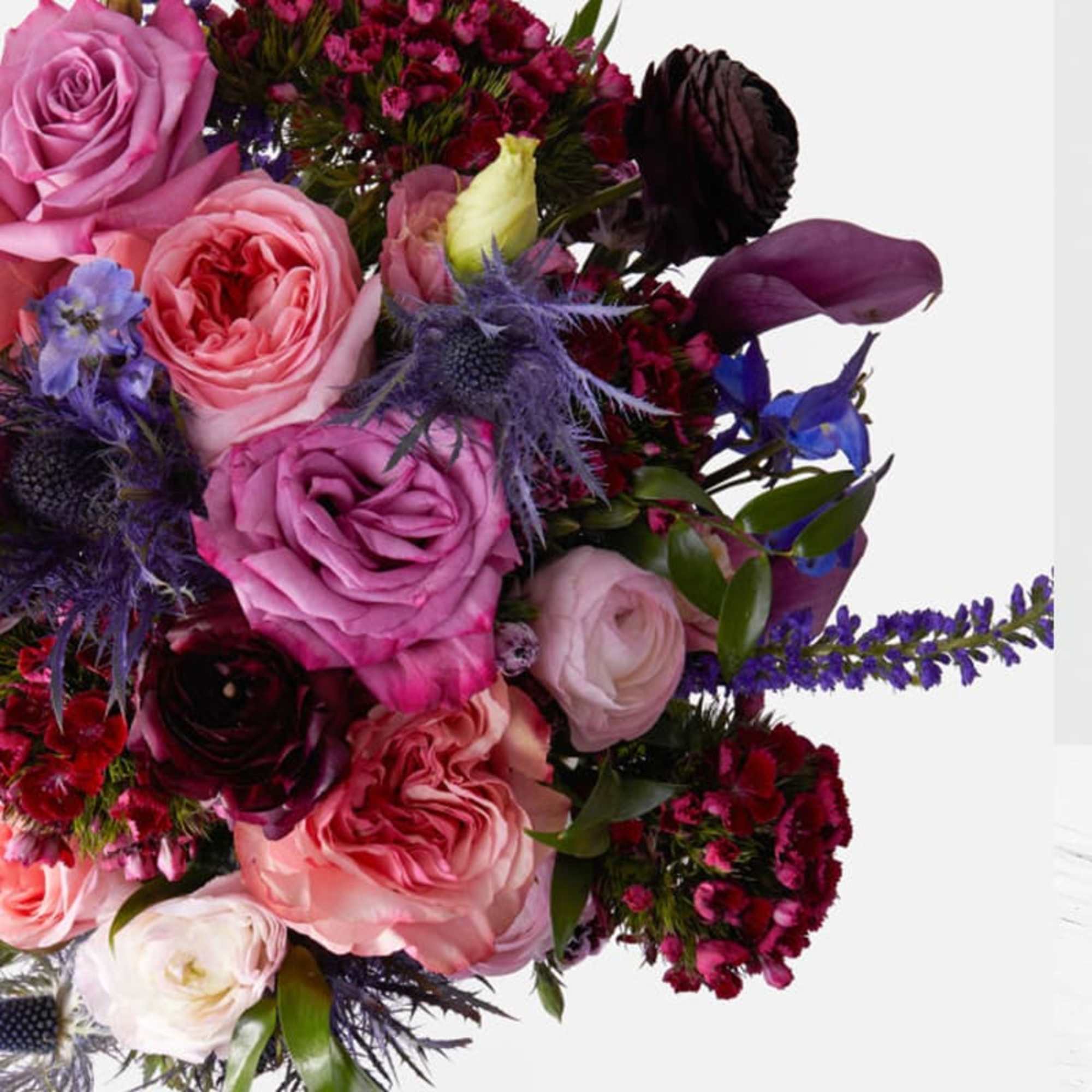 Bouquet of pink and purple roses with blue accents