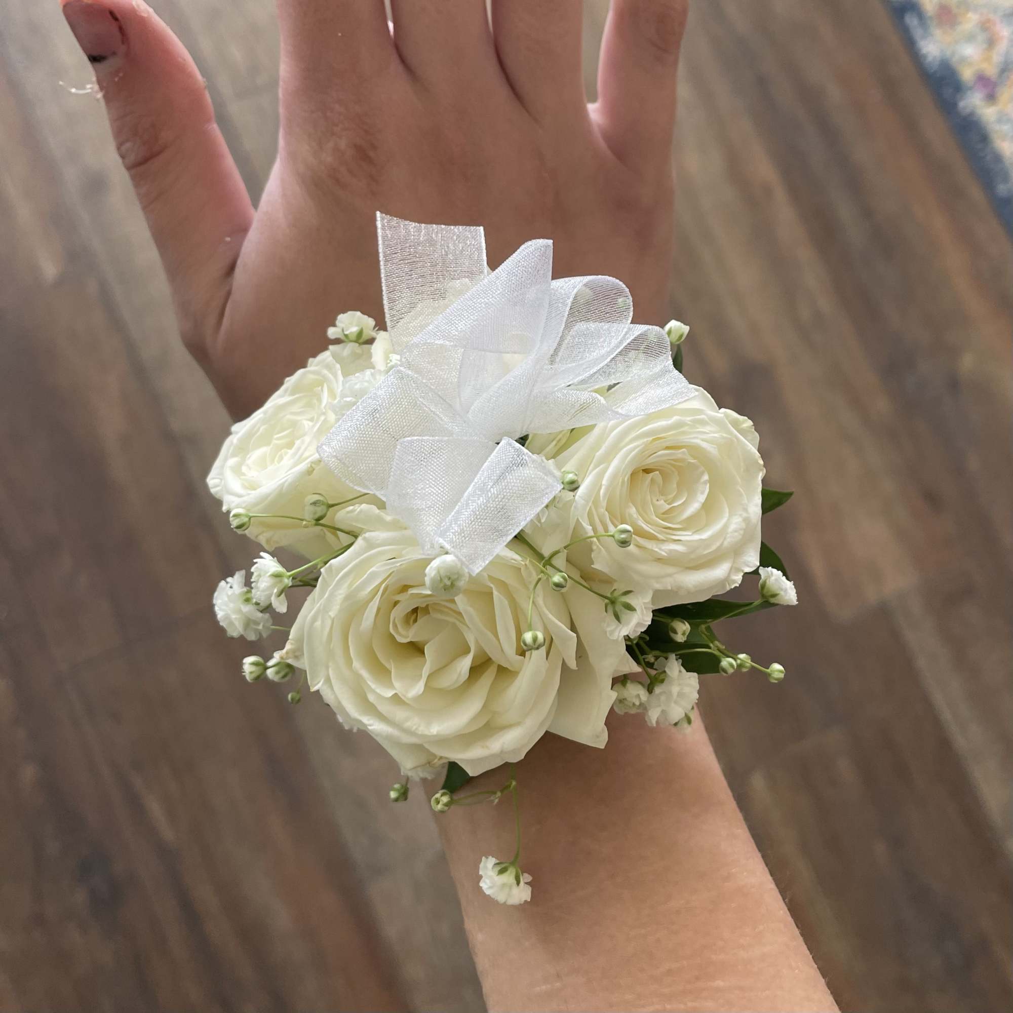 White rose wrist corsage with a sheer ribbon bow