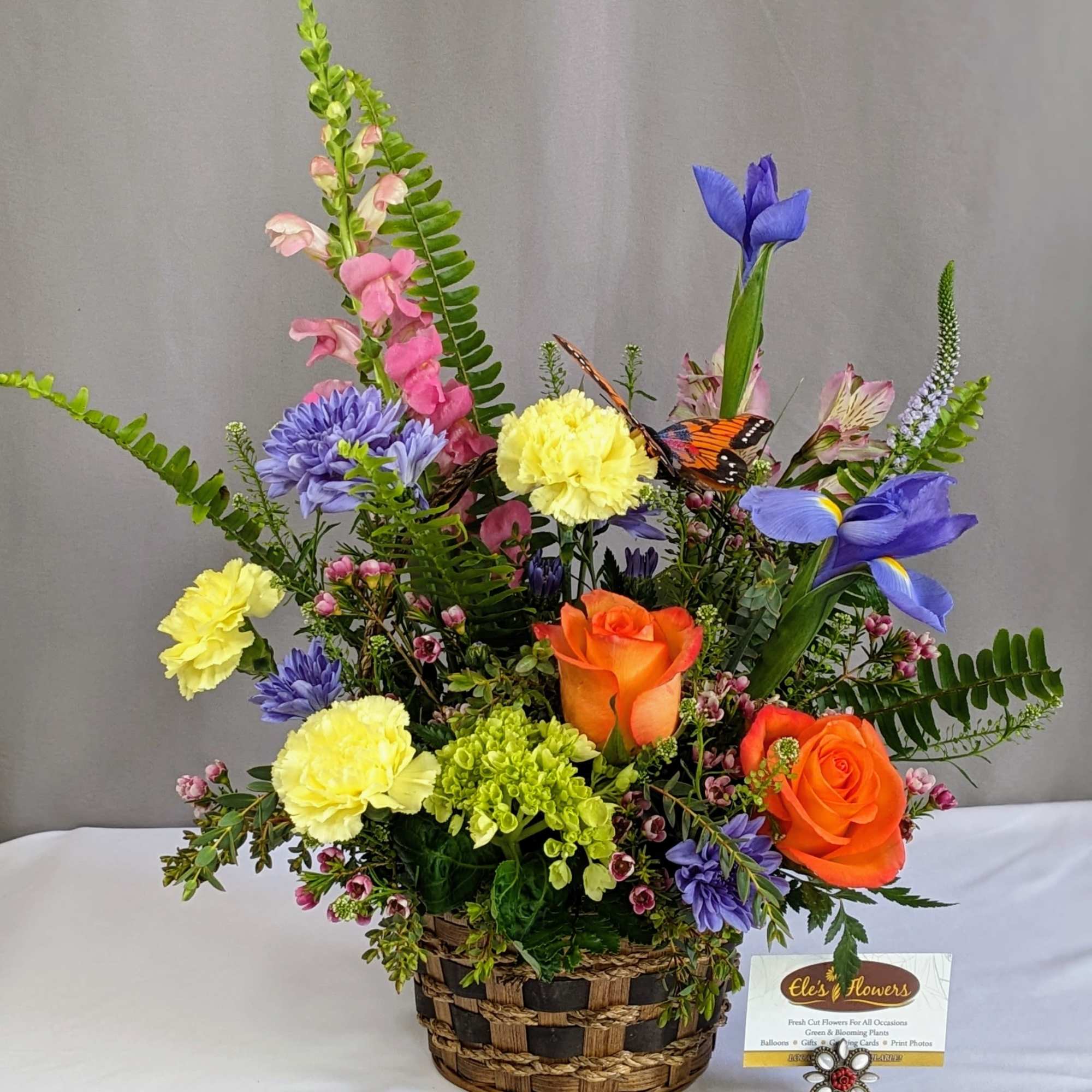 This cheerful spring arrangement bursts with fresh, vibrant color and natural movement