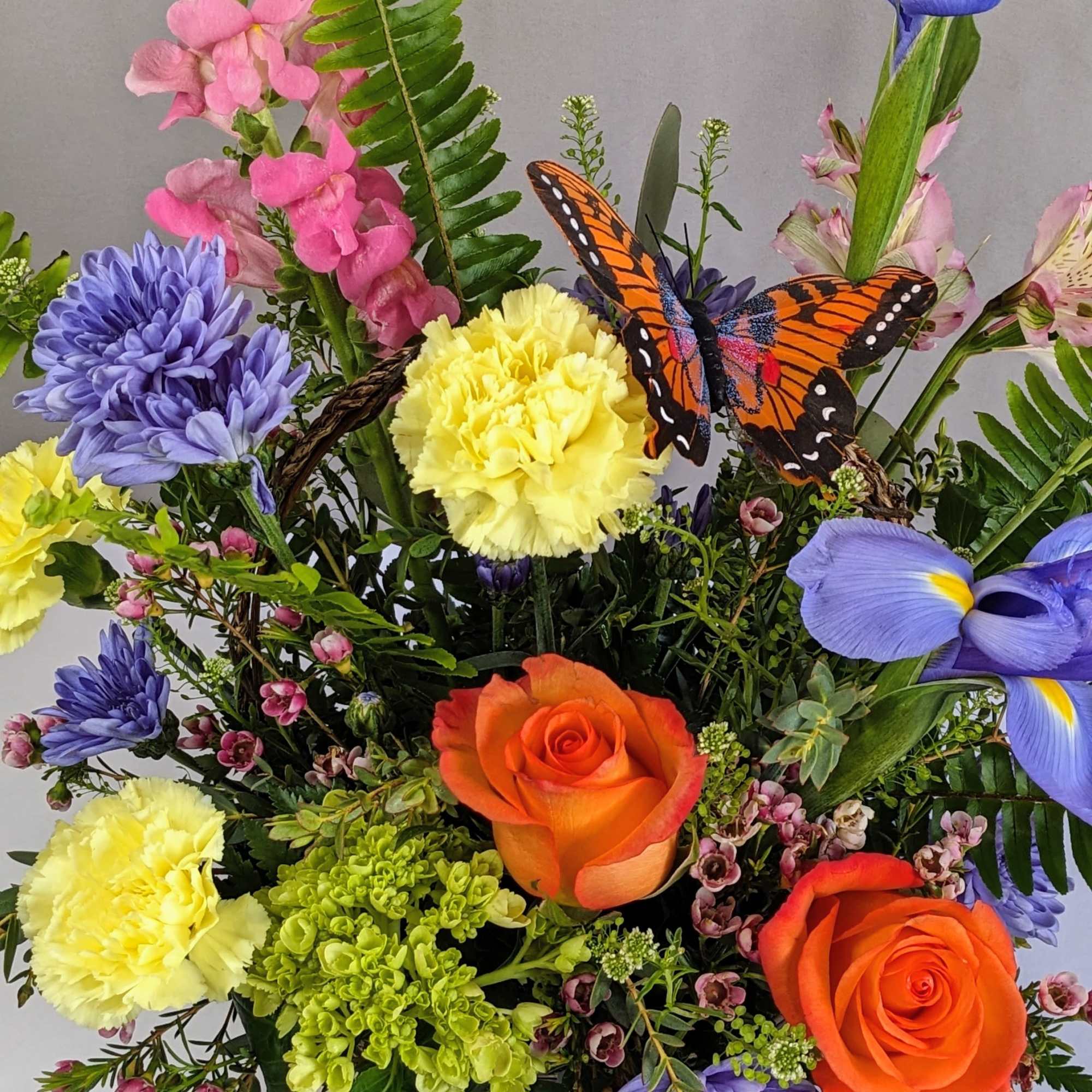 This cheerful spring arrangement bursts with fresh, vibrant color and natural movement