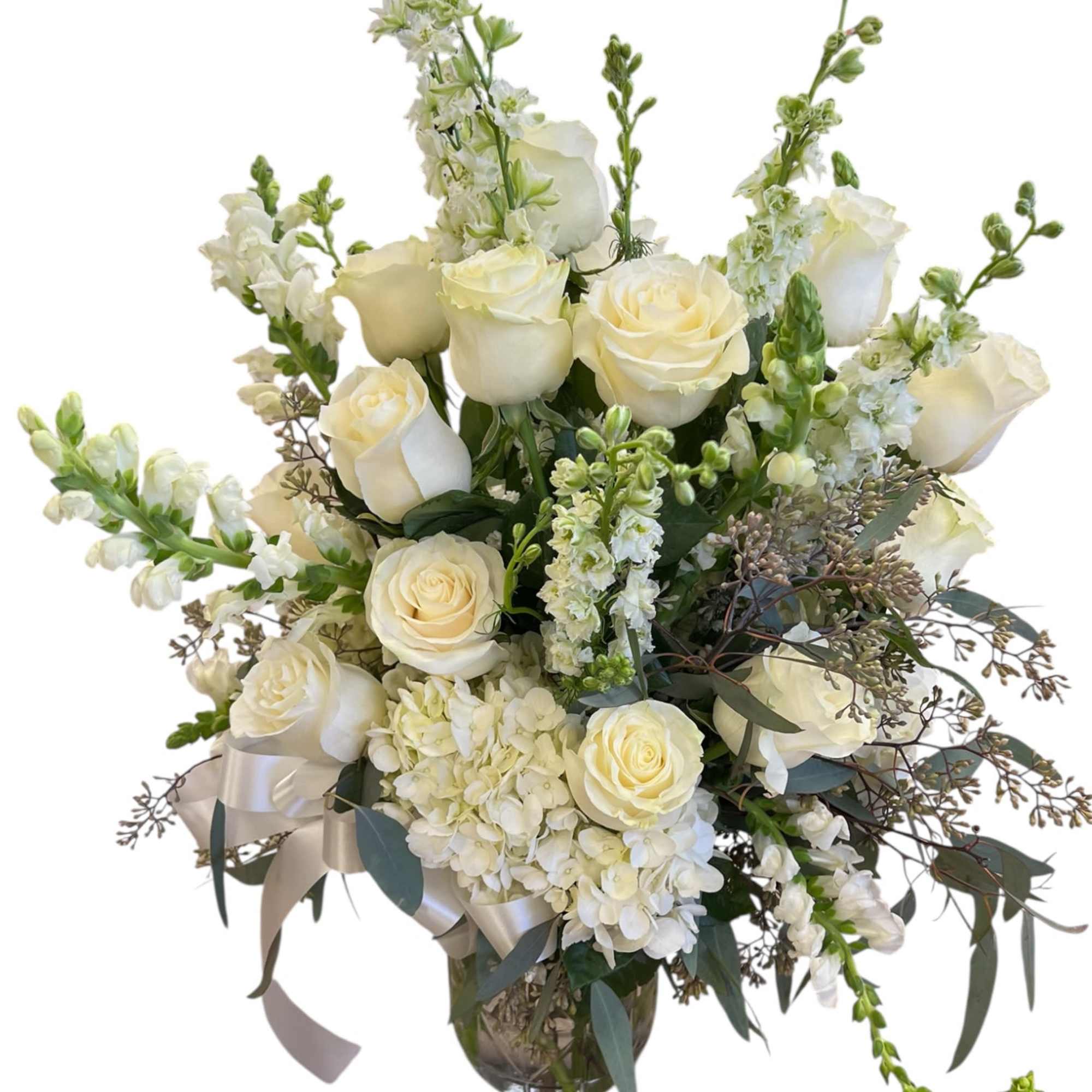 This timeless all-white arrangement brings a sense of serenity and respect, making