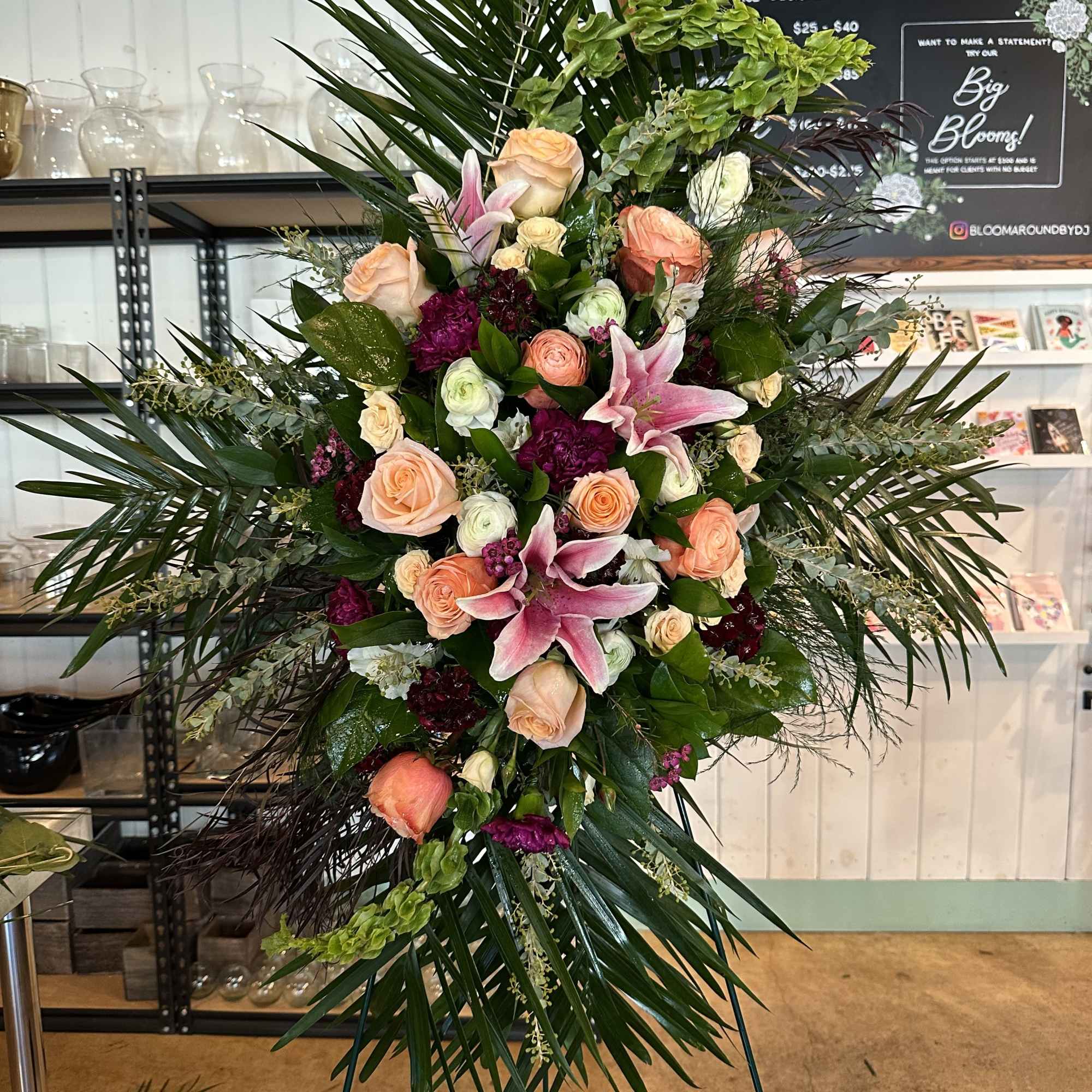 Large standing floral spray with pink lilies and peach roses