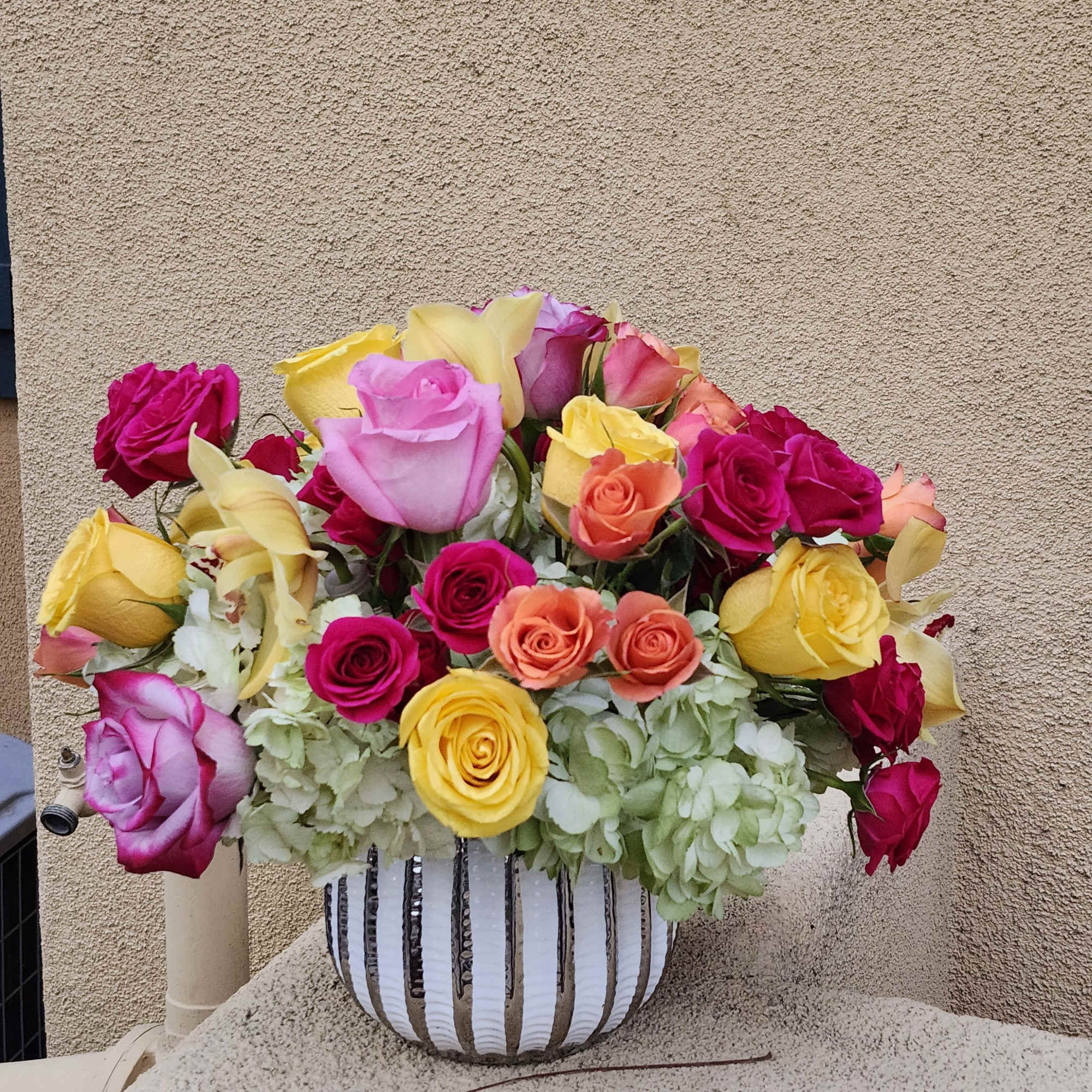 This cylindrical vase of flowers is kind of like a time capsule