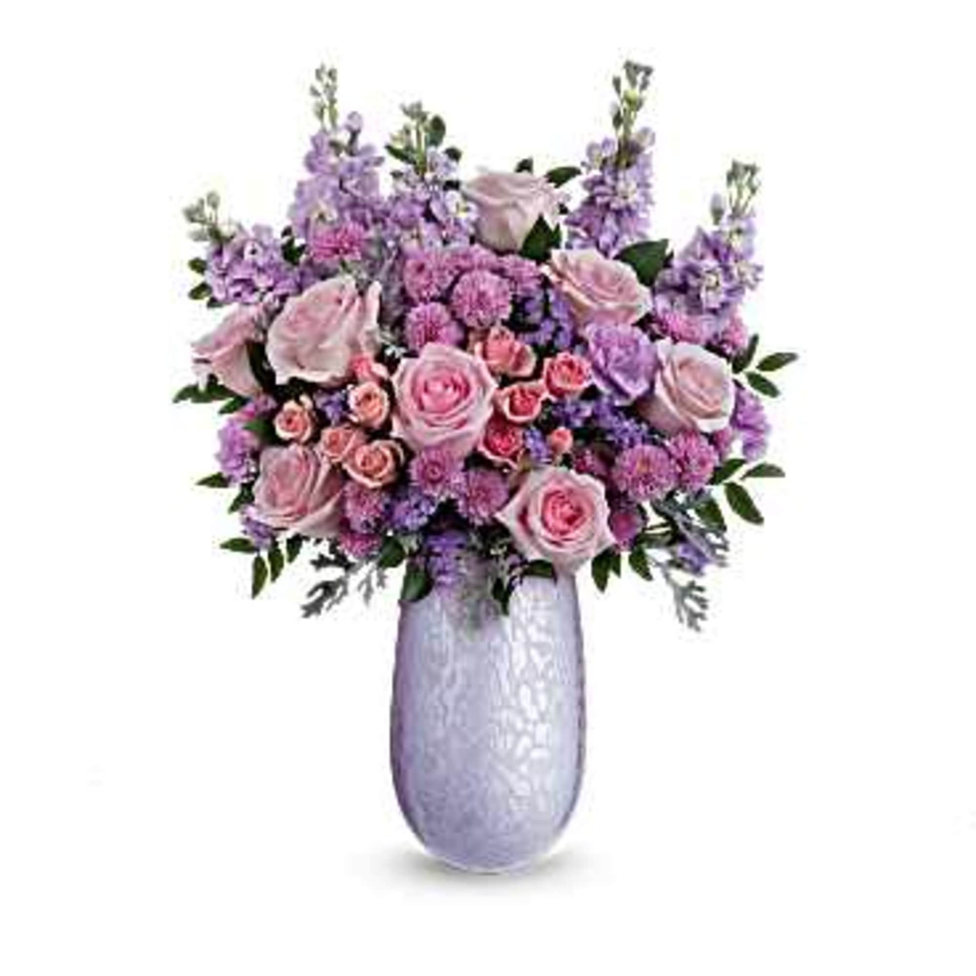 Pink and lavender flower arrangement in a tall vase