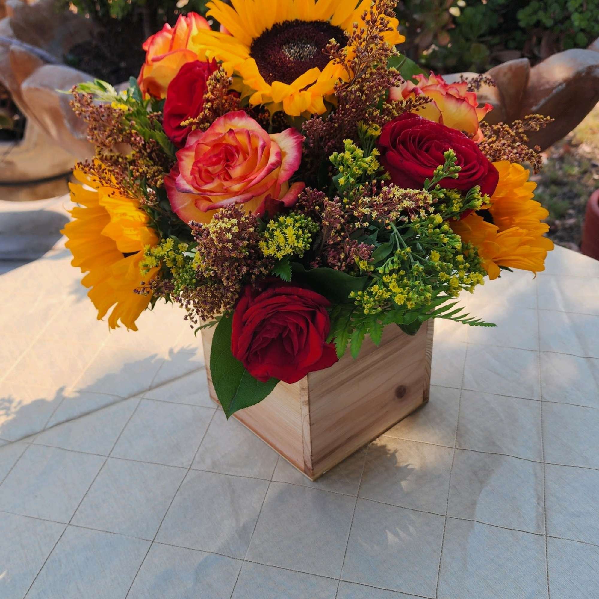Full low arrangement with Red Roses, yellow/orange Roses, Sunflowers Solidago  low