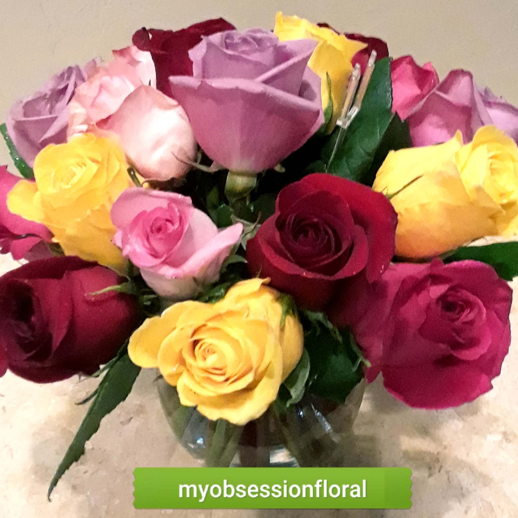 Bouquet of multicolored roses in a glass vase