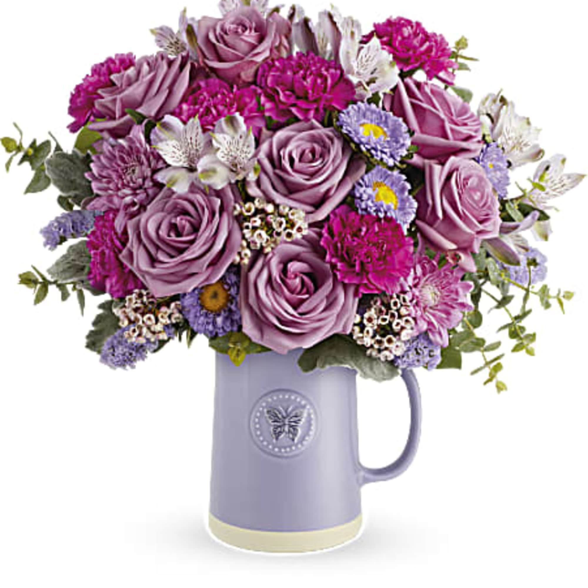 Lavender and pink bouquet in a purple mug vase