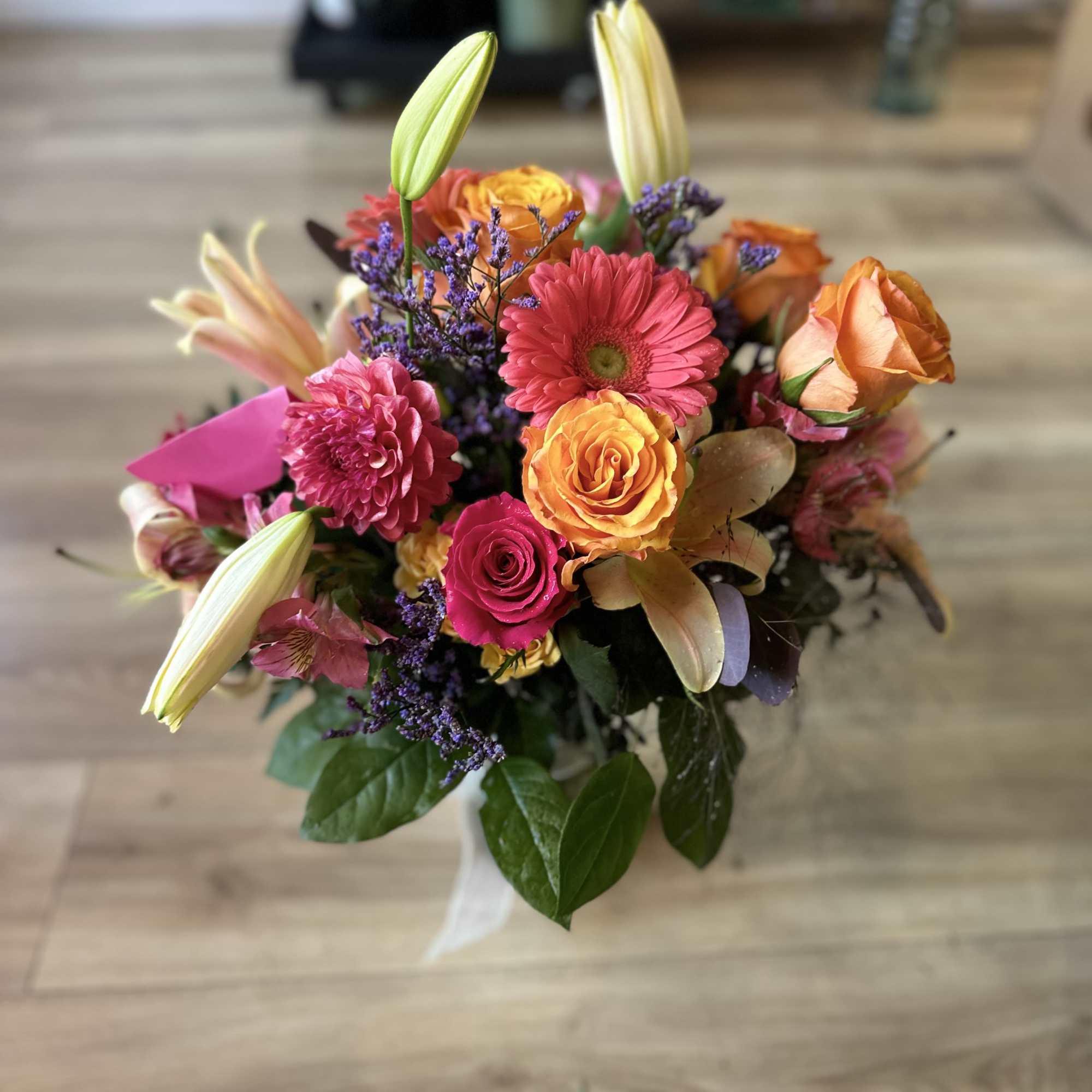 Mixed bouquet of roses, gerbera daisies, lilies, and purple filler flowers