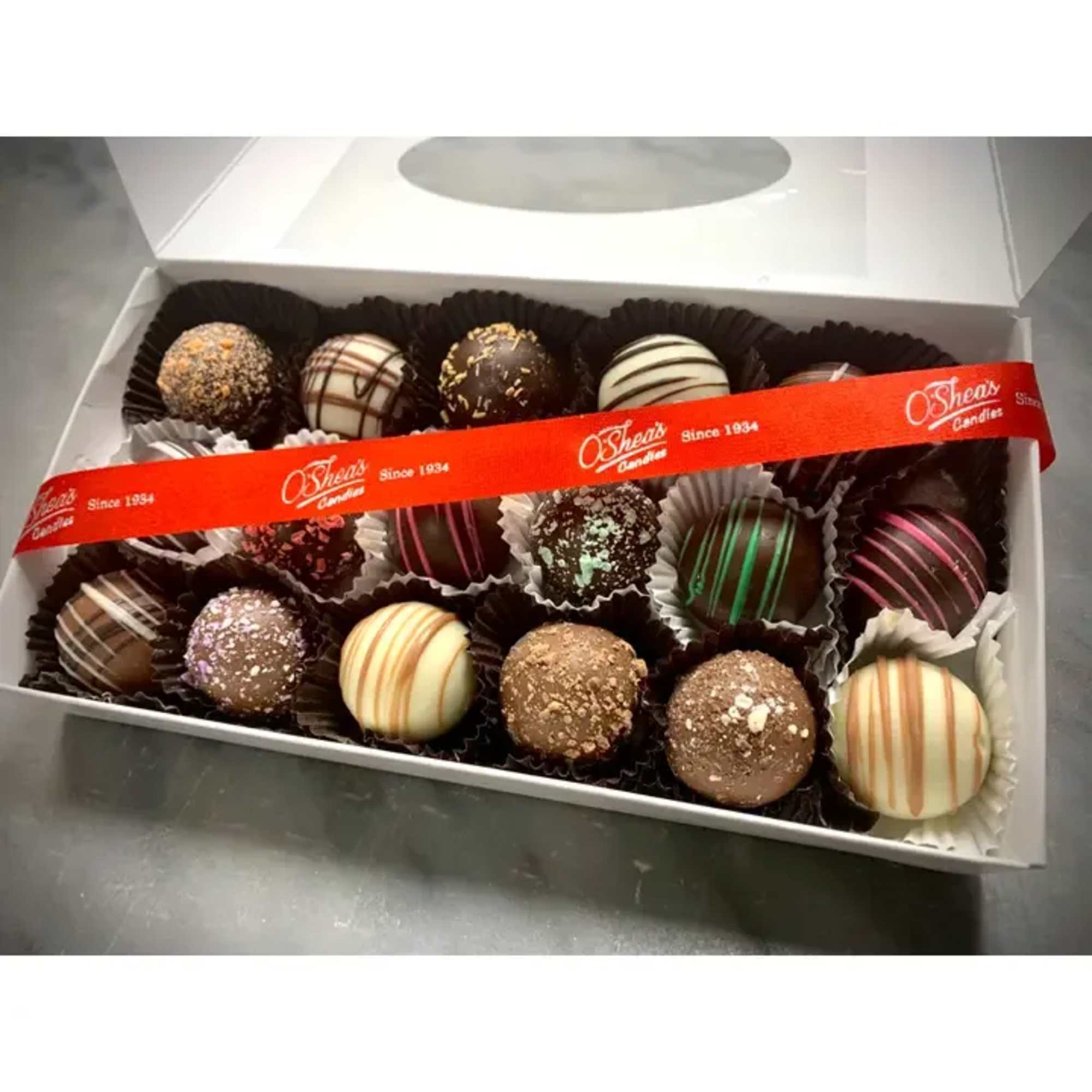 Box of assorted chocolate truffles with a red ribbon