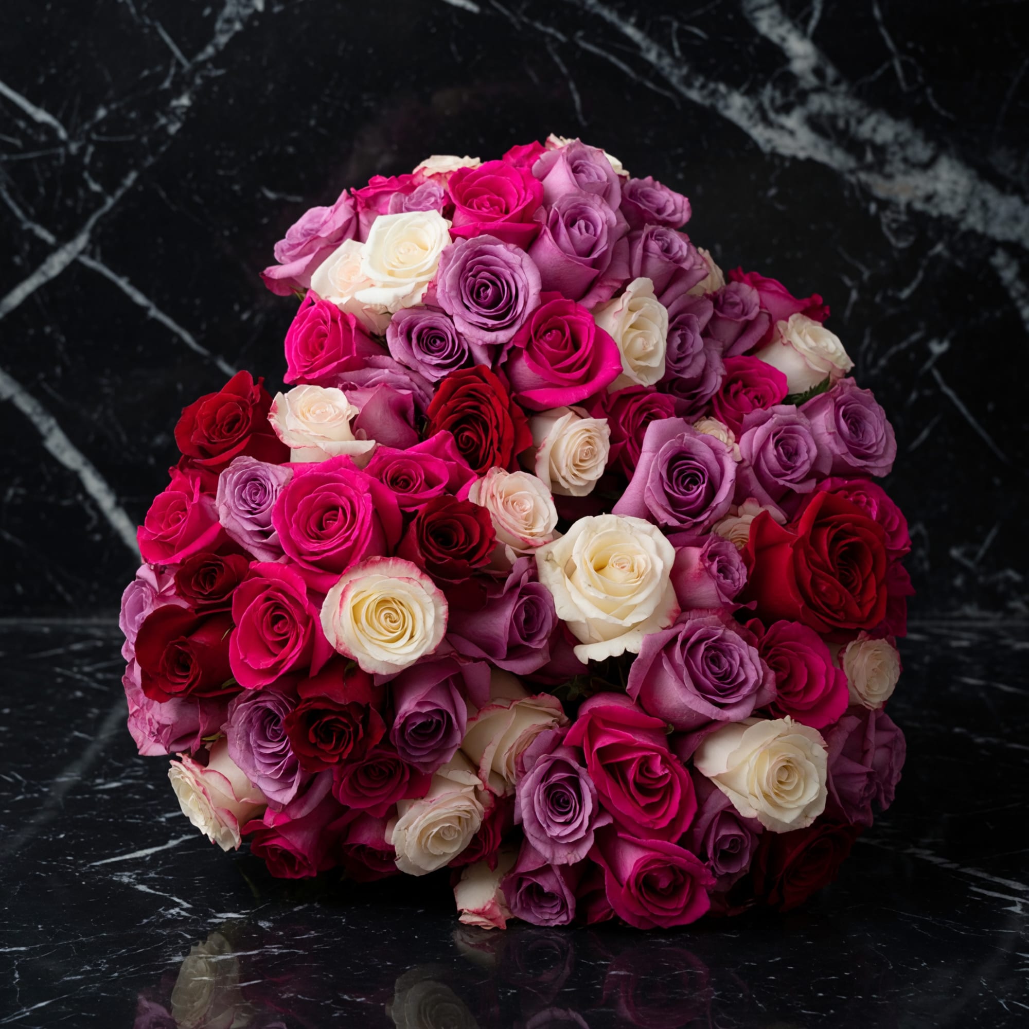 Roses, lilies, carnations, and alstroemeria in pinks, purples, red, and white a