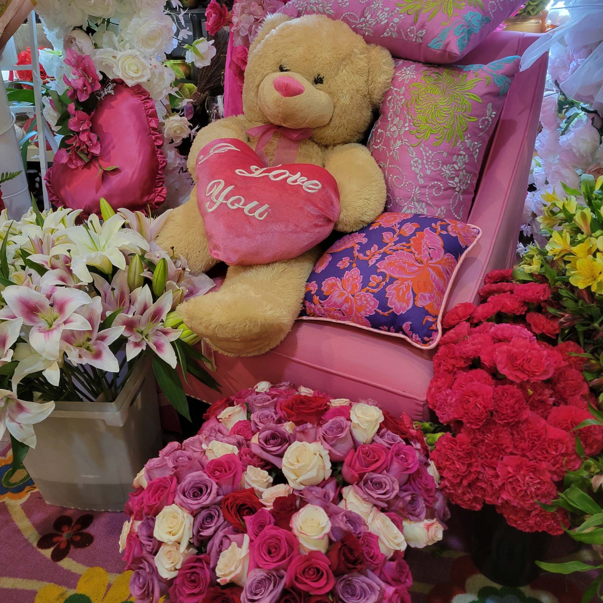 Roses, lilies, carnations, and alstroemeria in pinks, purples, red, and white a