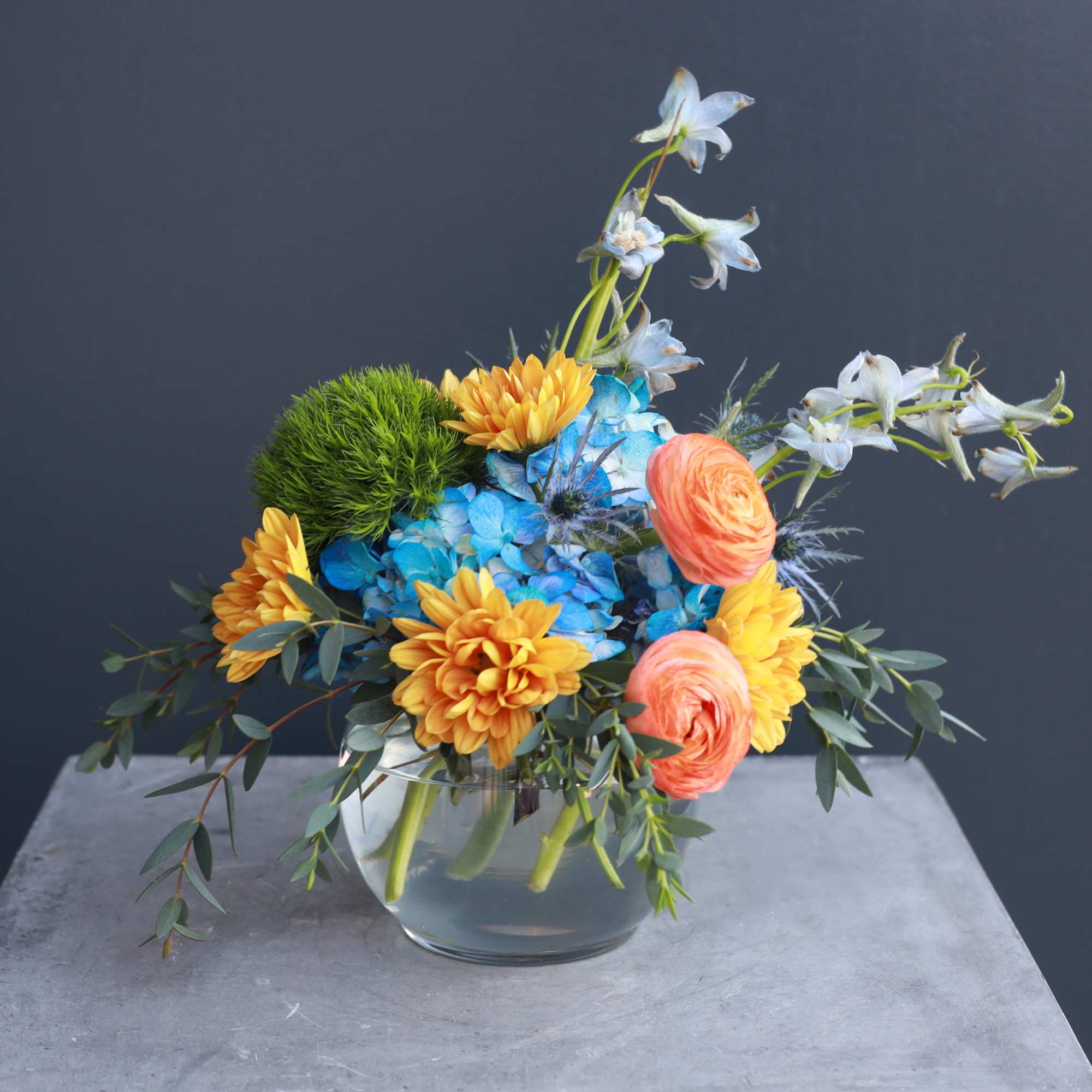 A small fun colorful arrangement that is a dynamite of color and