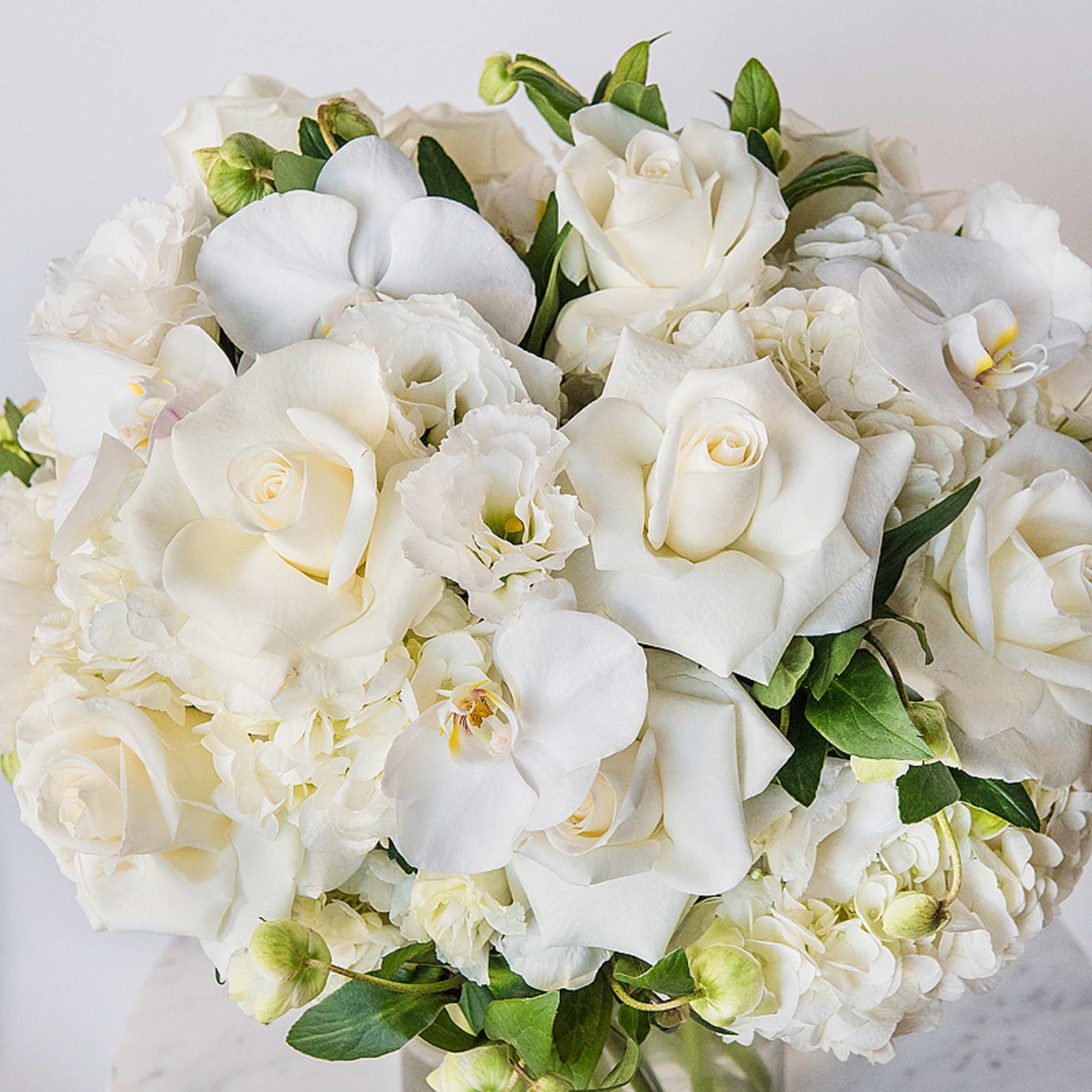 White bouquet with roses, orchids, and calla lilies