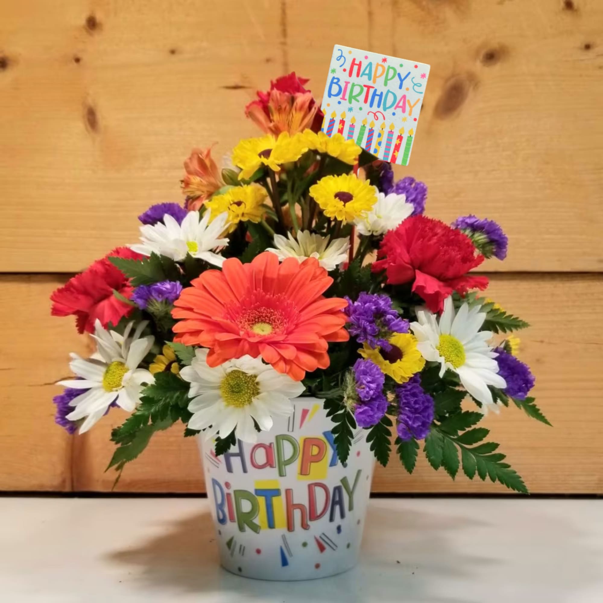 Mixed bouquet in a birthday bucket with a card topper