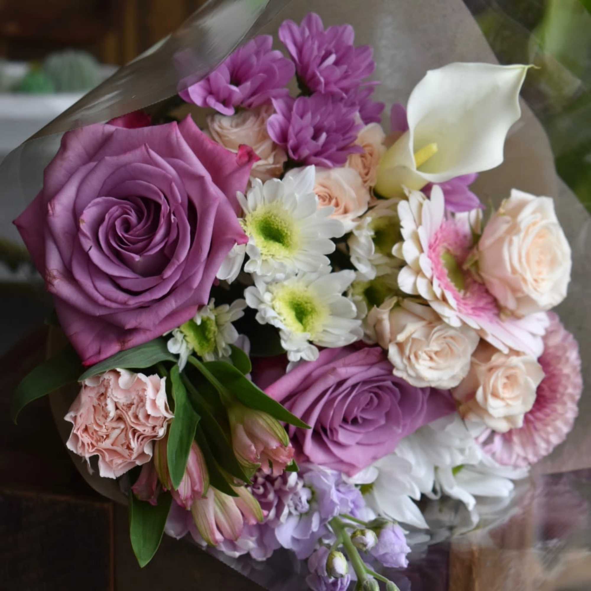 A hand-tied bouquet featuring the freshest flowers available in our shop. Each