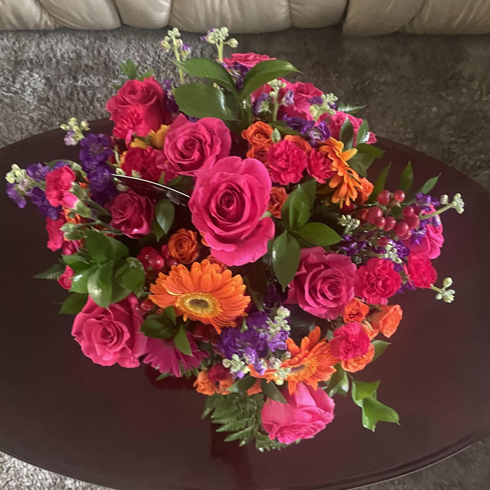 Bright mixed bouquet of pink roses and orange gerbera daisies