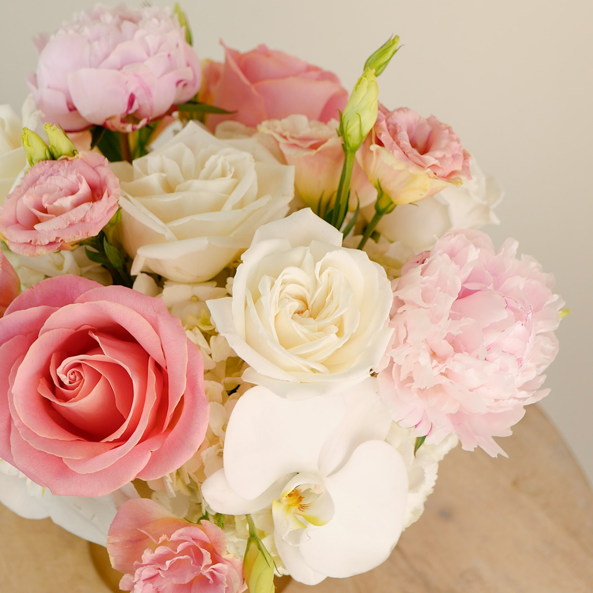 Pink and white roses with pale pink blooms in a bouquet