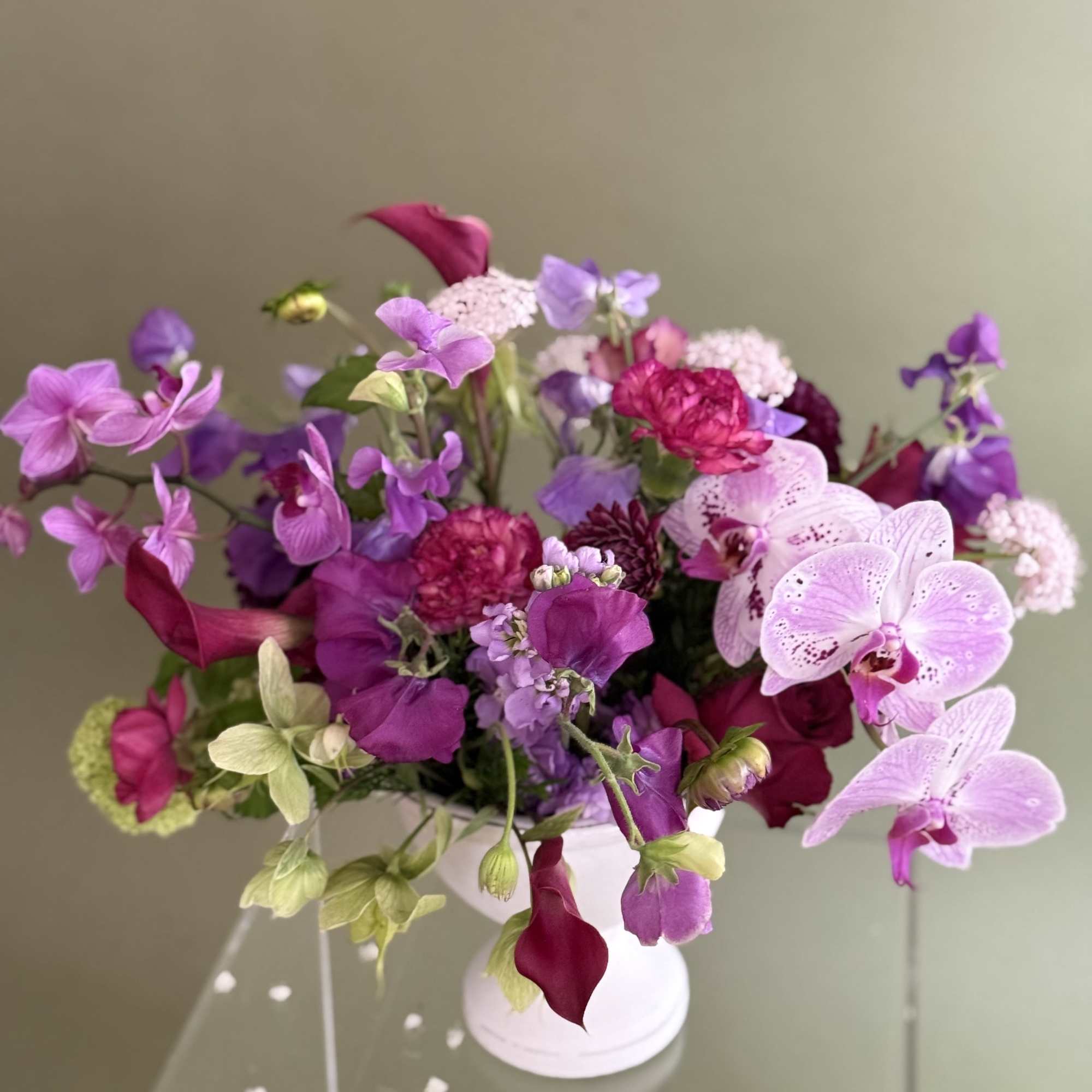 Pink and purple mixed bouquet in a white vase
