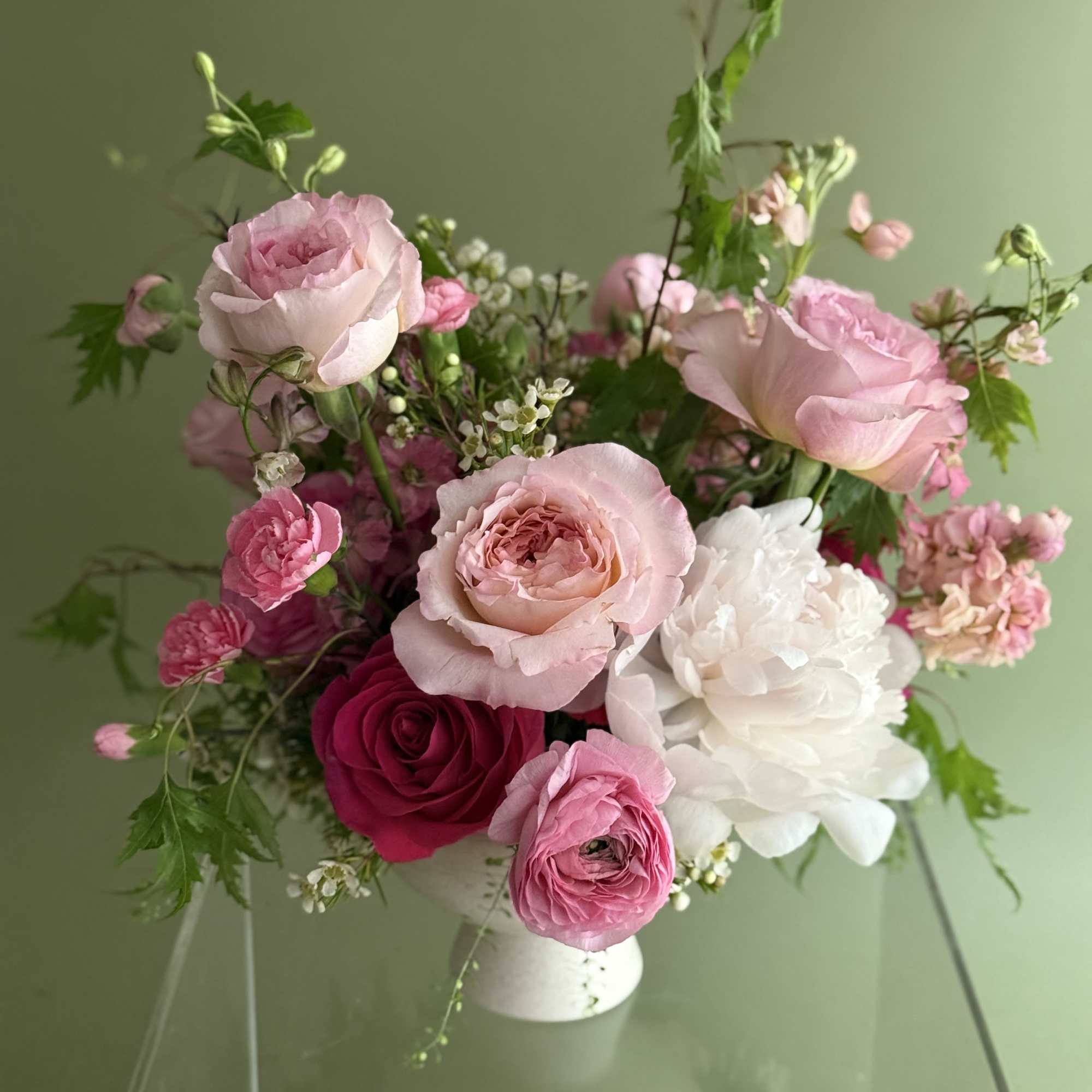 Pink and white rose bouquet in a white vase