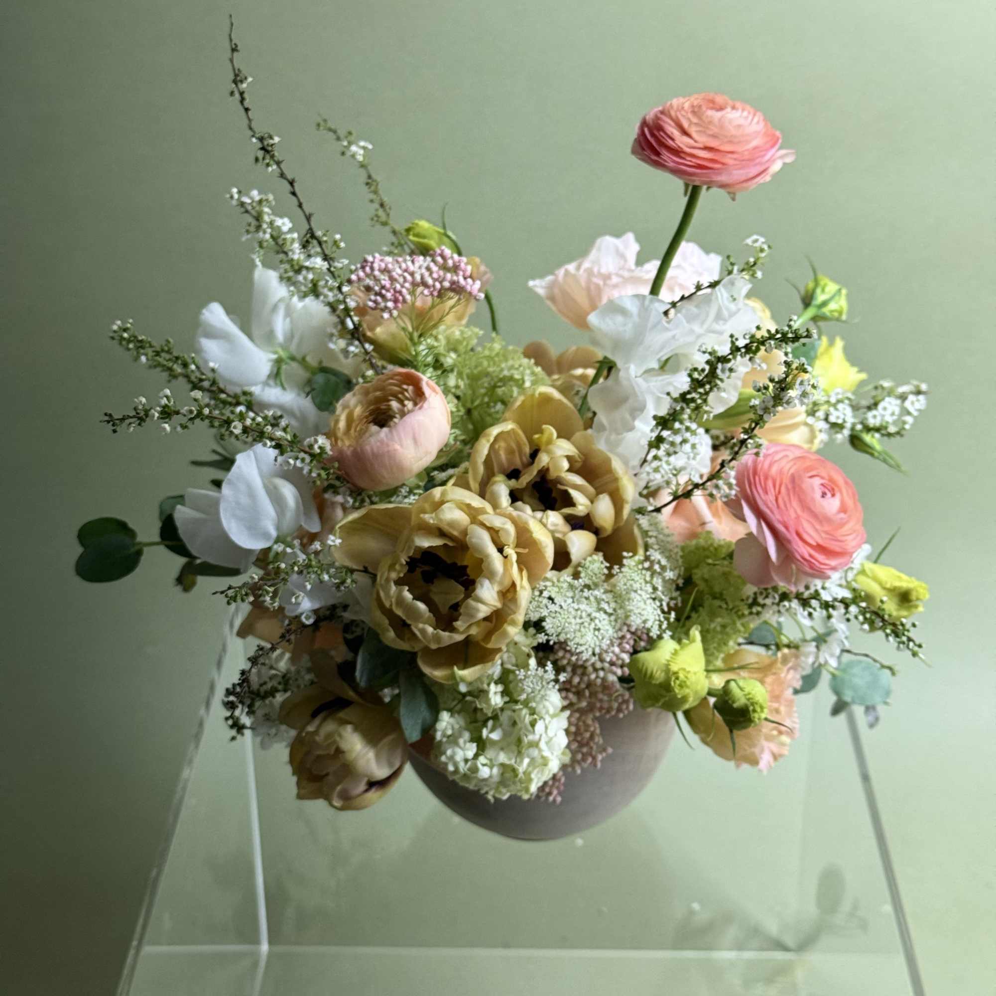 Mixed bouquet in a round vase with pink, white, and yellow blooms
