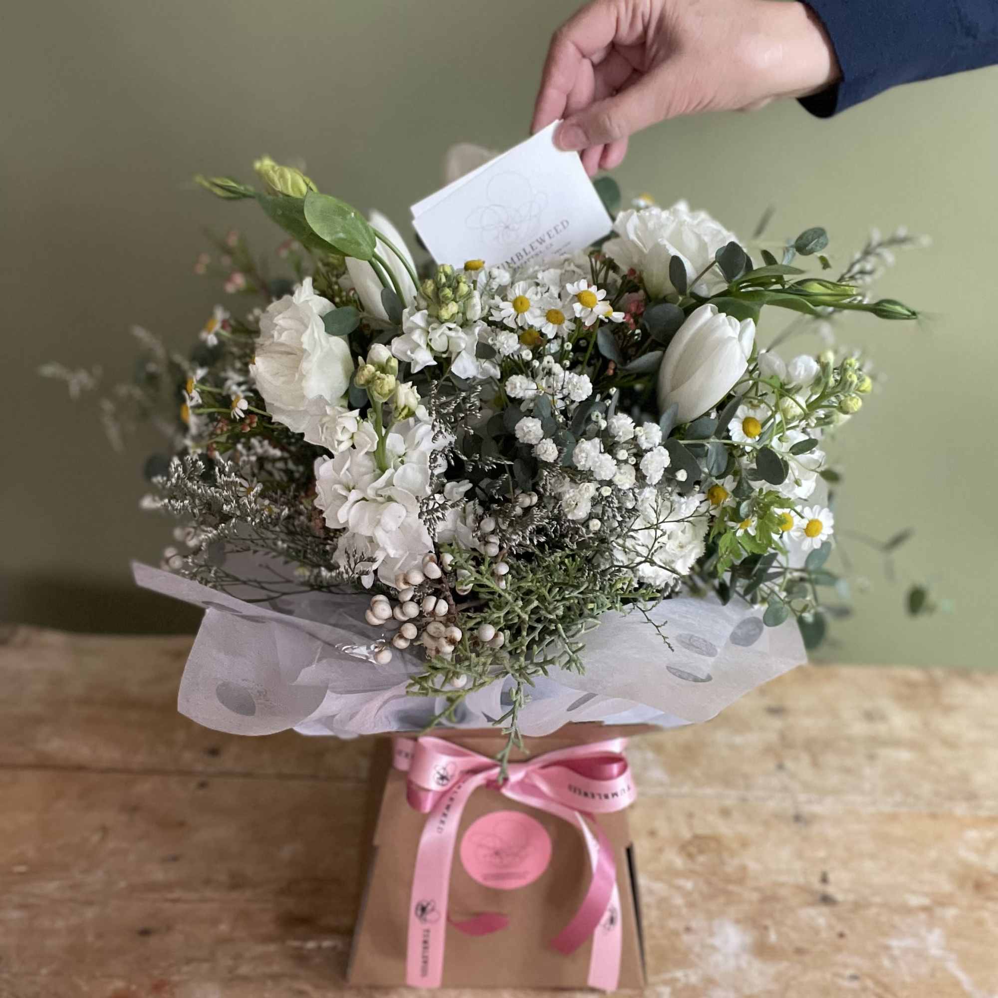 White mixed bouquet in a gift box with a pink ribbon