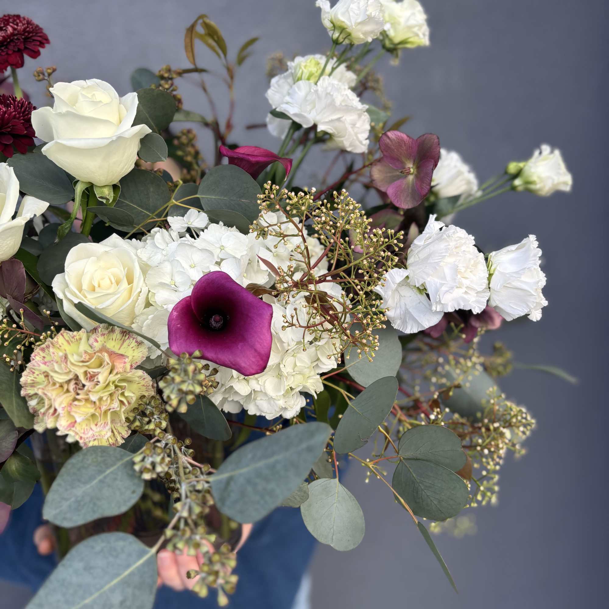 Bouquet of white roses, white hydrangea, and purple calla lilies
