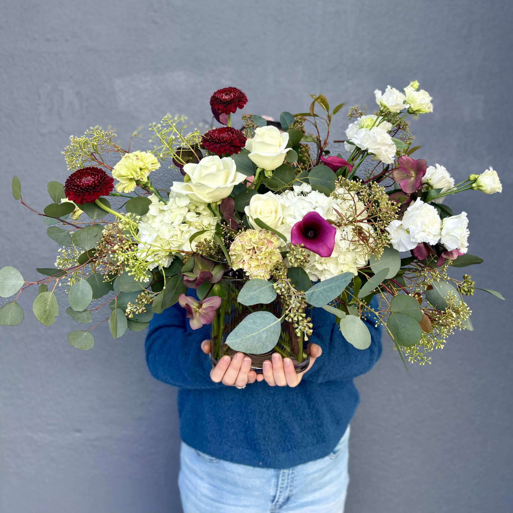 Mixed bouquet in a glass vase with white and burgundy flowers