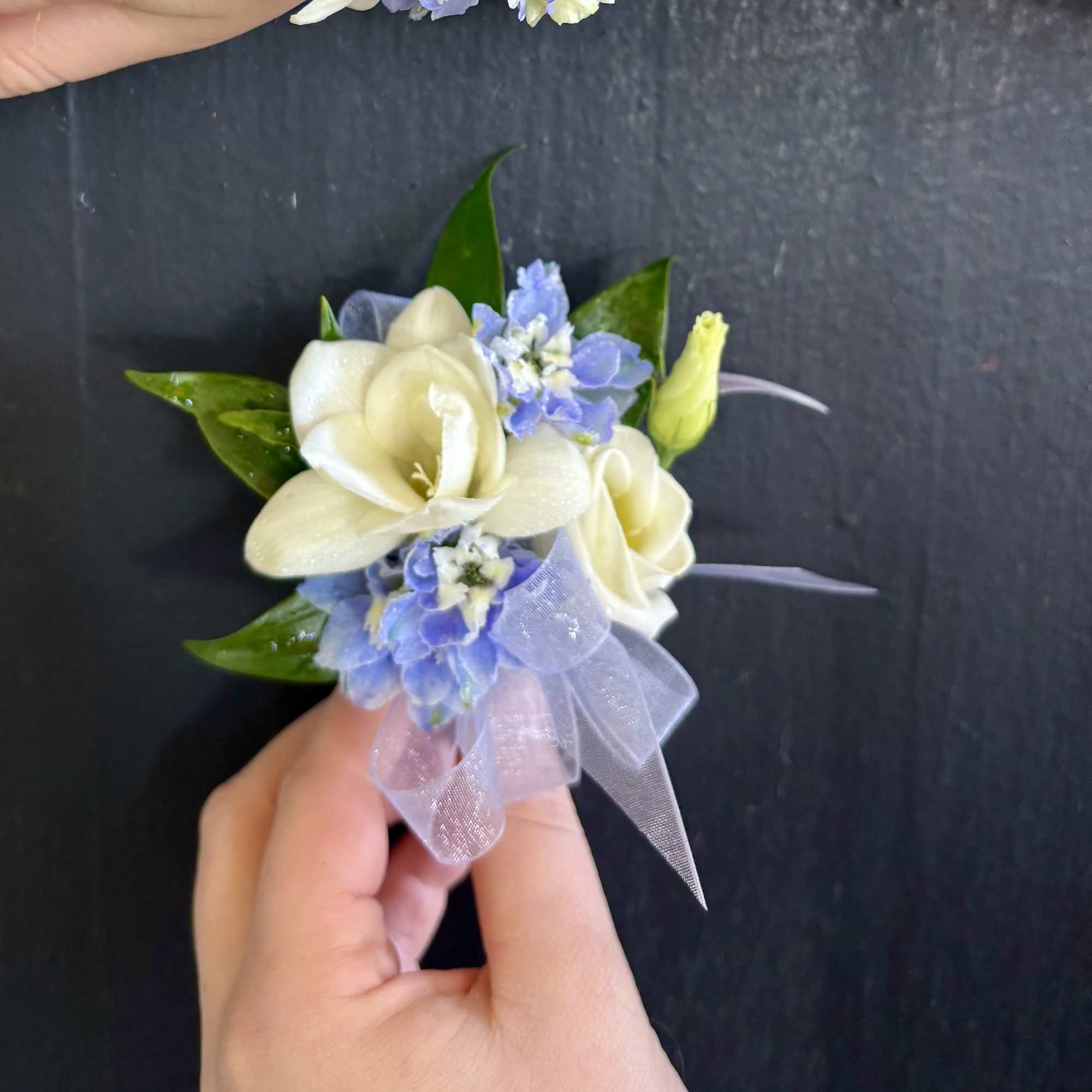 A Corsage and Boutonniere set in Blue and White. Topped off with